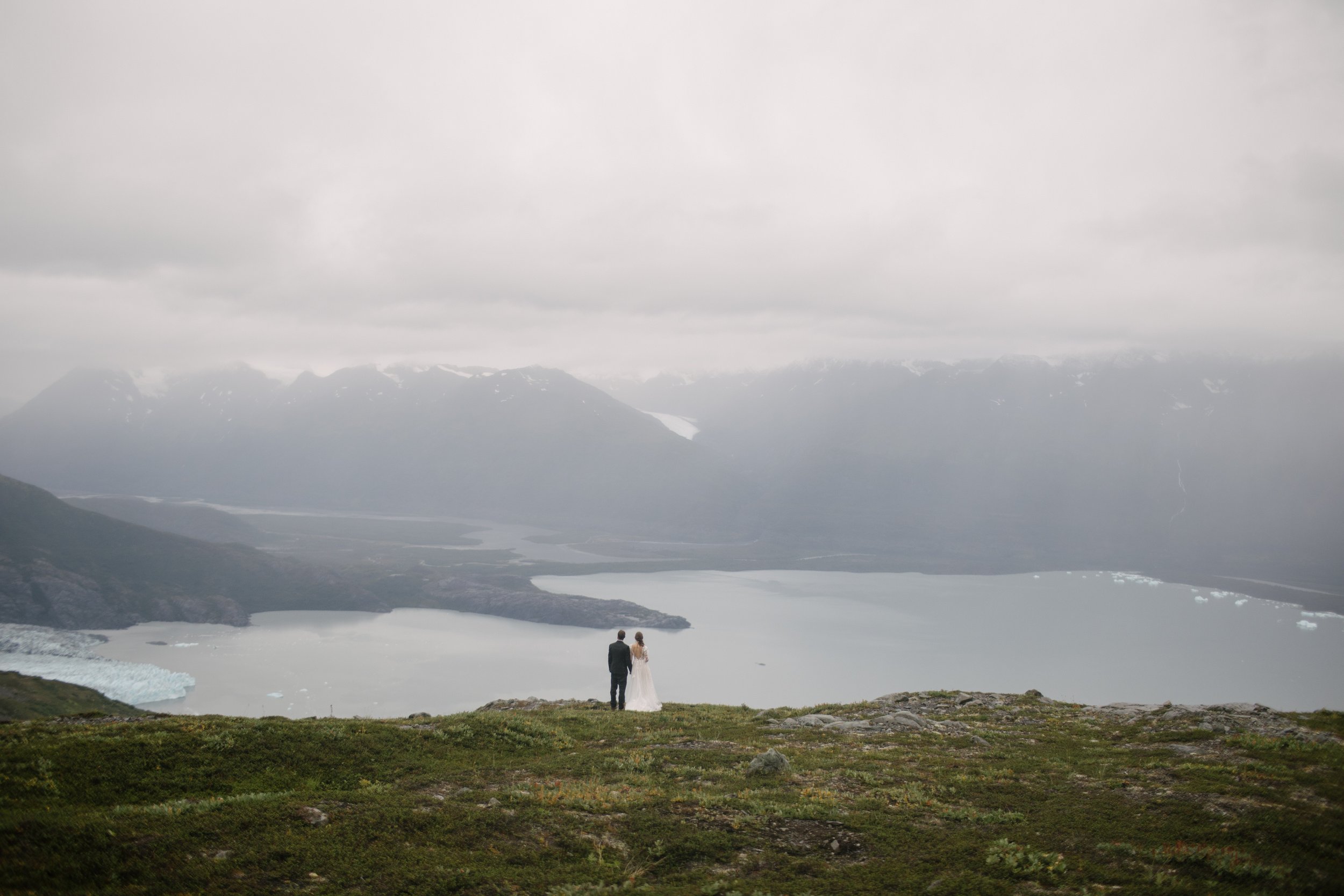 couple looking at alaska wilderness during elopement