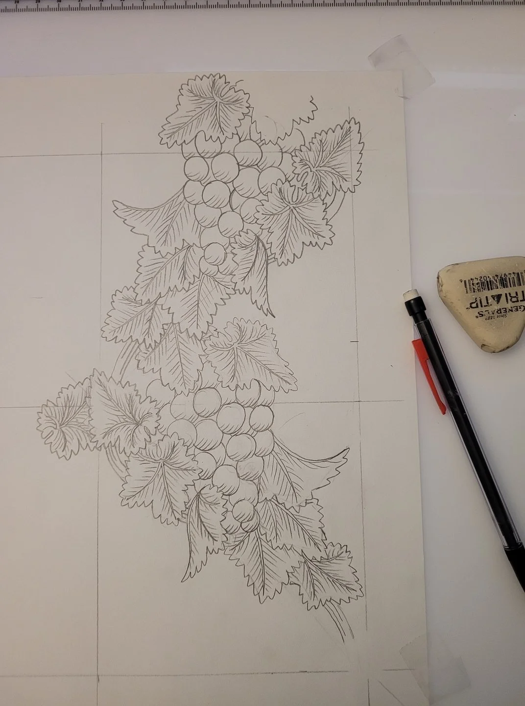 I'm using a lightboard to work on a grape vine damask pattern. I trace the outline of the motif and copy it in reverse. Once I digitize this, I'll mirror it so that it repeats in a reflected design.