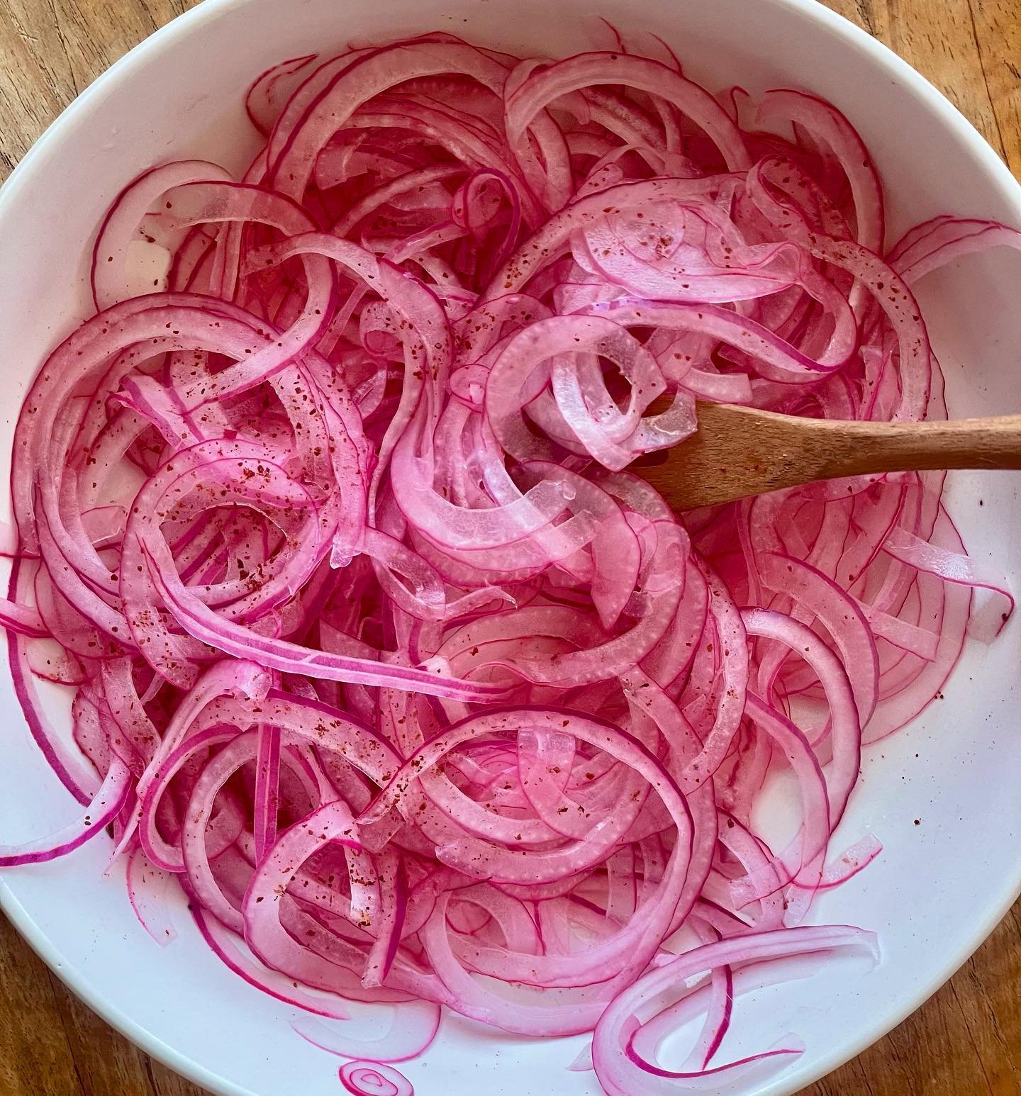 Pickled onions are a fridge staple for me. My rough rule of thumb is one red onion for one lemon (roughly the same size as each other). 

Finely slice the onion with a knife or mandolin, squeeze the lemon juice over it, a pinch of salt and a pinch of