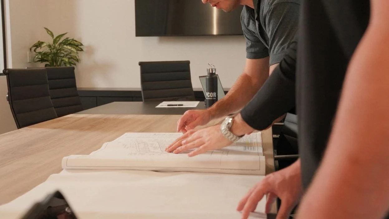 Team ahnds on large construction plan