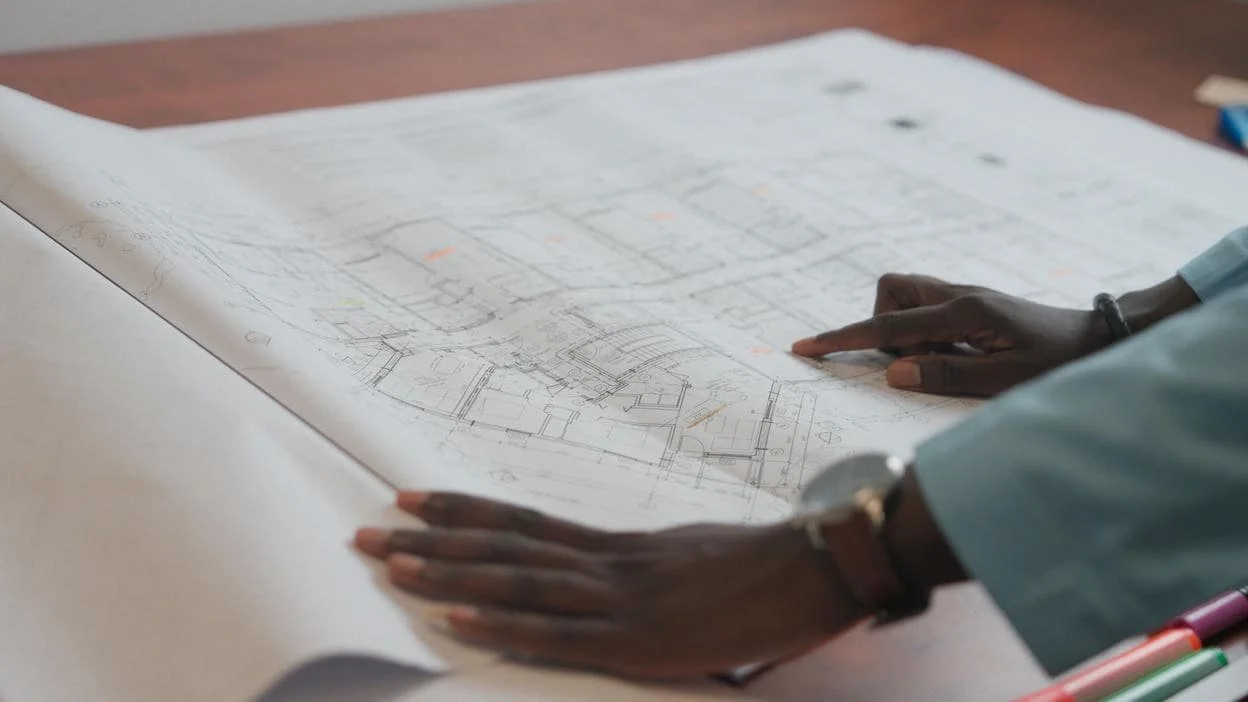 hands on large construction plan