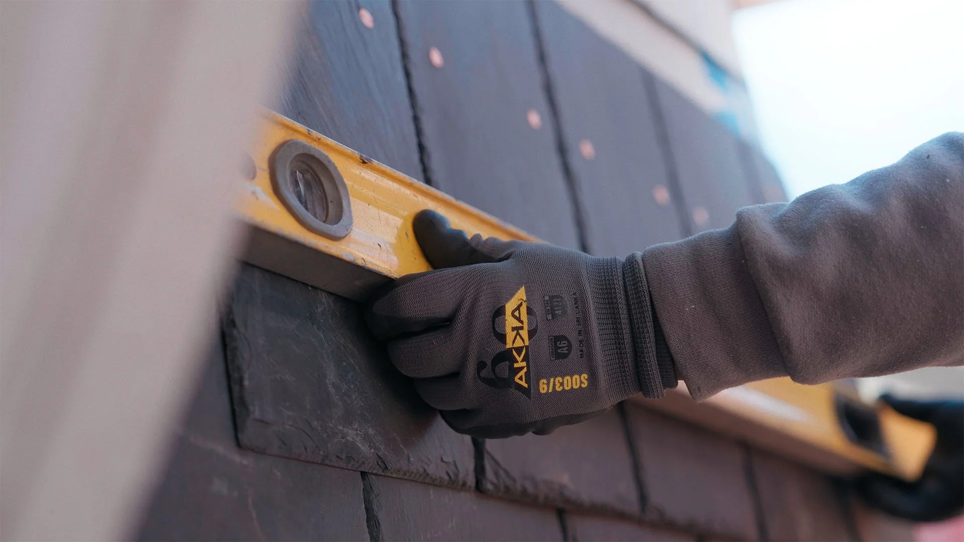 closeup of hands holding a construction level