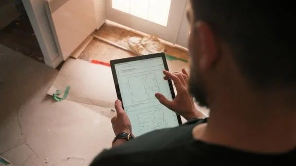 Contractor looking at iPad