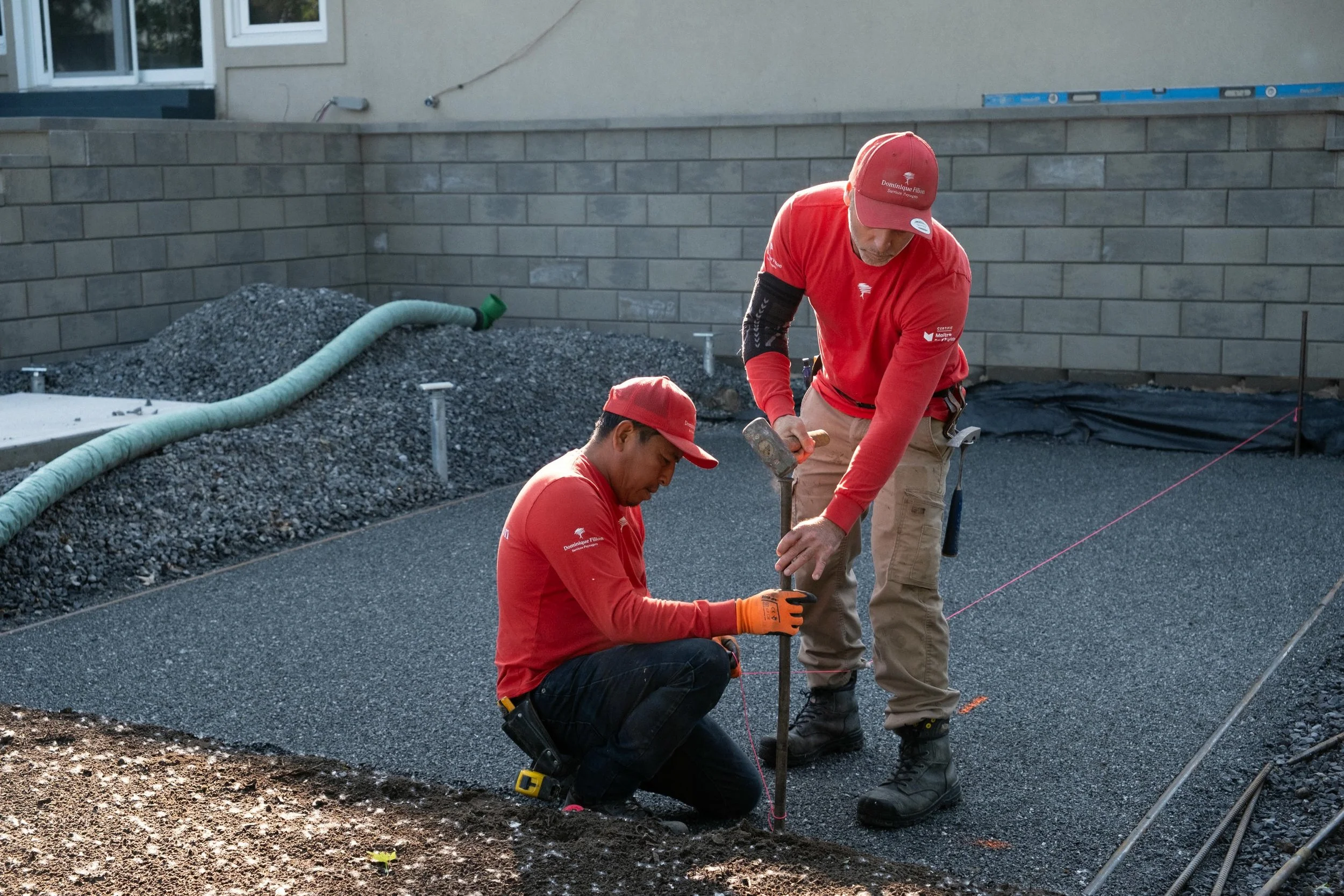 Landscape workers leveling surface of the ground