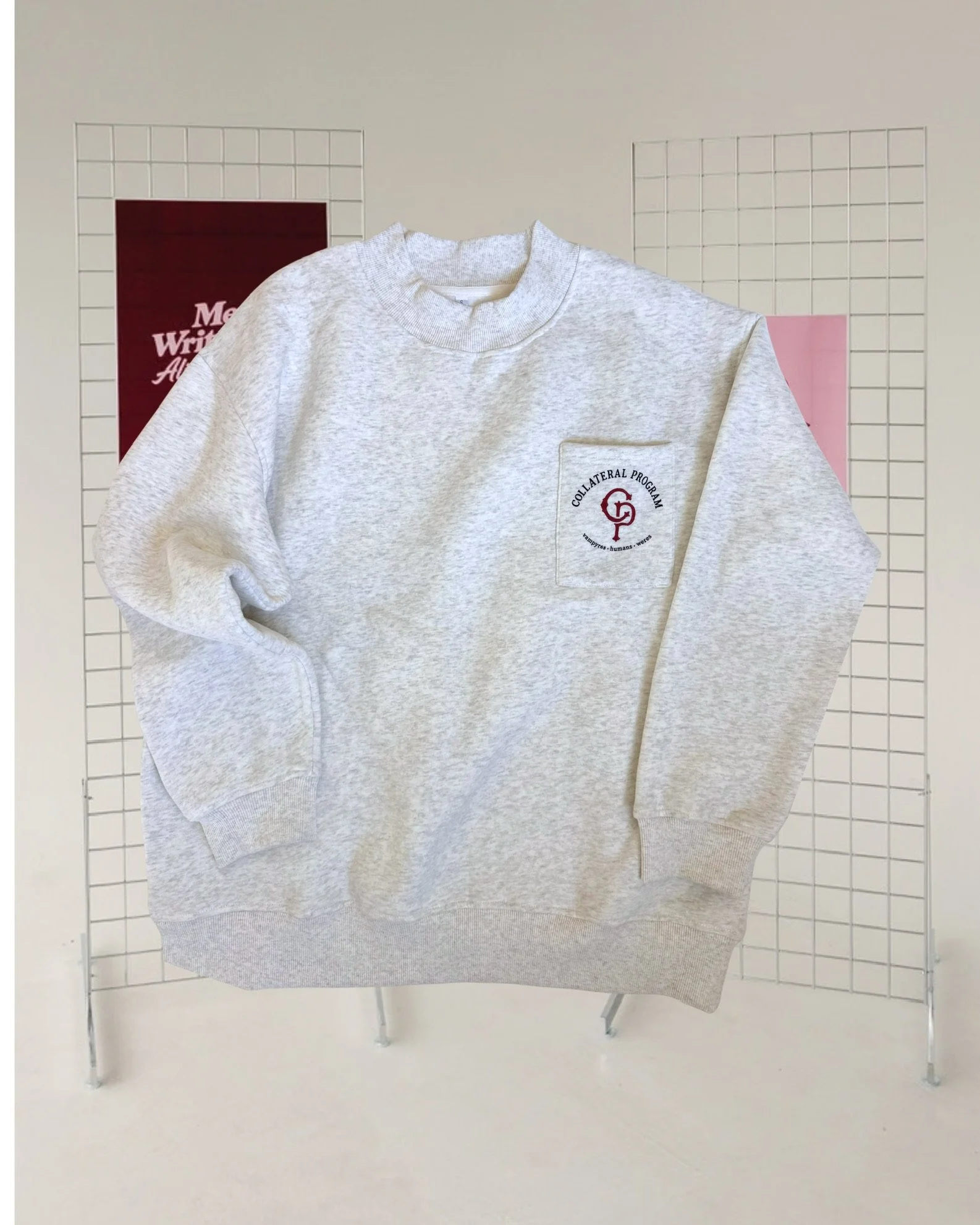 Grey marl mockneck sweatshirt with a chest pocket and “The Collateral Program” design inspired by Ali Hazelwood’s Bride.