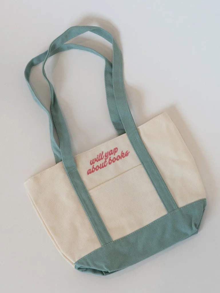 Will Yap About Books embroidered canvas tote bag with blue straps and pink lettering, a cute bookish tote for readers, book lovers, bookstore trips, and book club gifts.