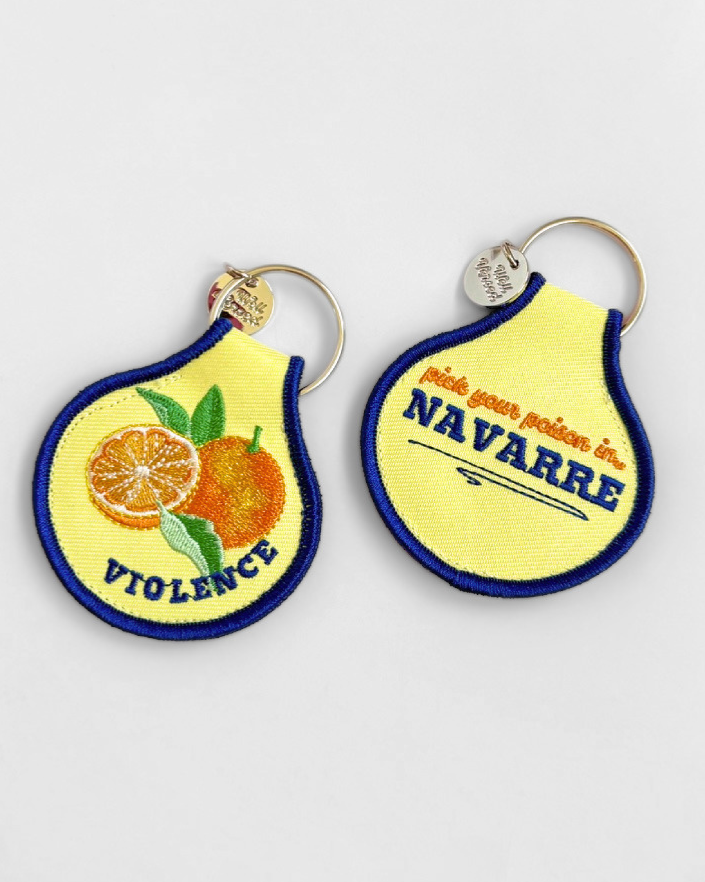 A cheeky embroidered keychain for romance and fantasy readers featuring a bright citrus design and “Violence” detail. A fun bookish accessory for keys, totes, and reading bags.