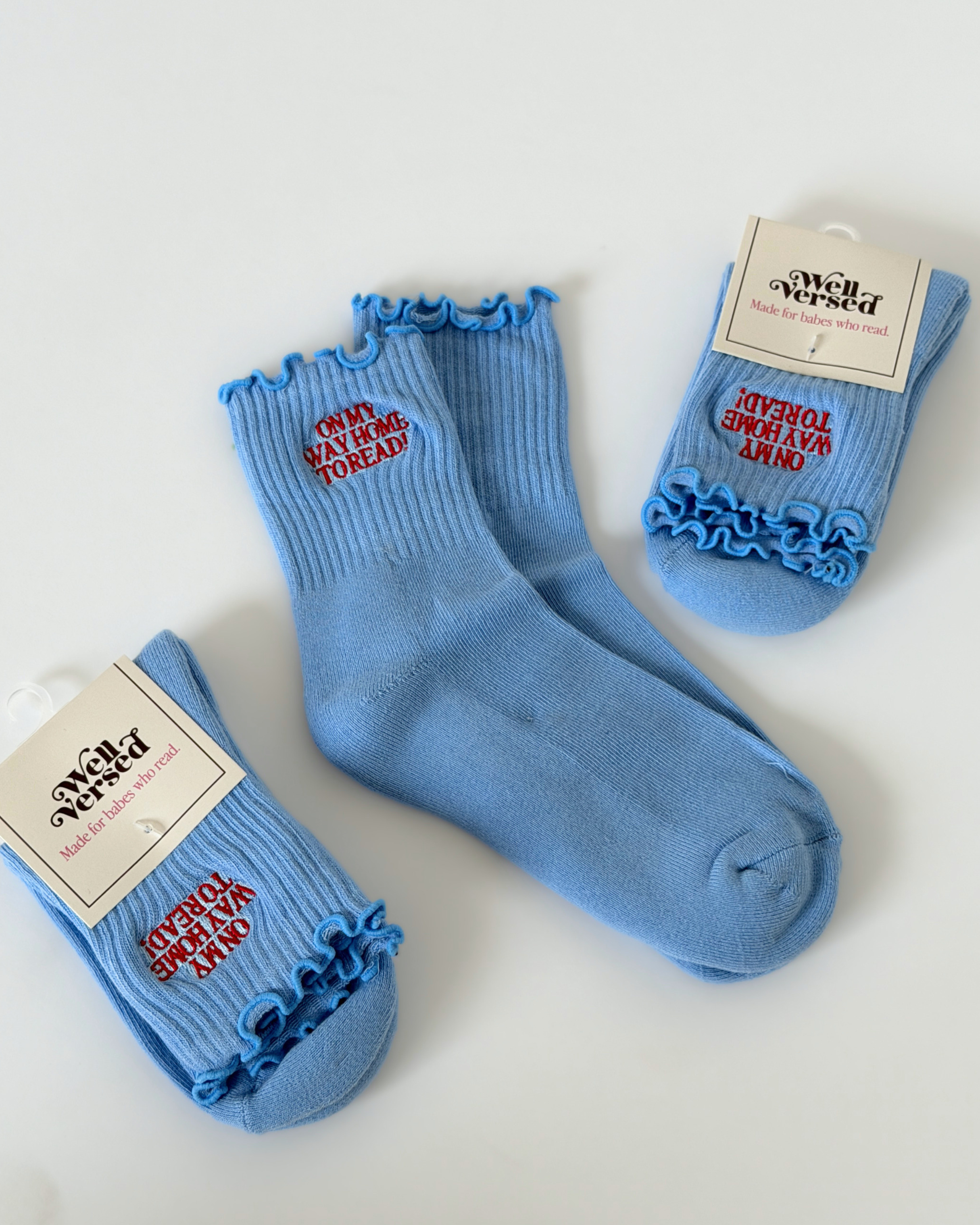 Bookish crew socks featuring embroidered reader-inspired sayings and designs, made for cozy reading days and gifting to book lovers.
