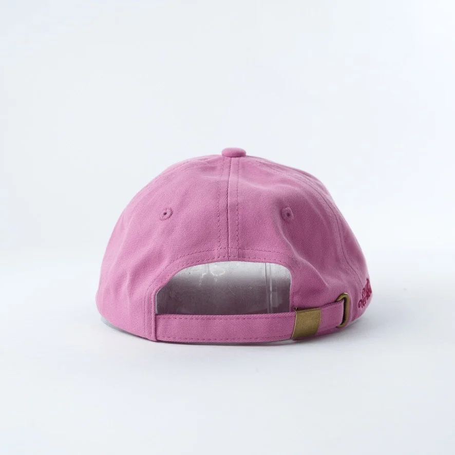Pink embroidered hat that reads book lover in red cursive with a gold metal clasp