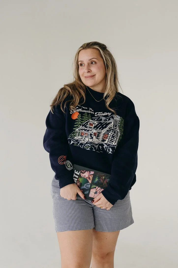 Navy mockneck sweatshirt featuring an illustration of Koen’s cabin inspired by Ali Hazelwood’s Mate, with a knot detail printed on the sleeve.