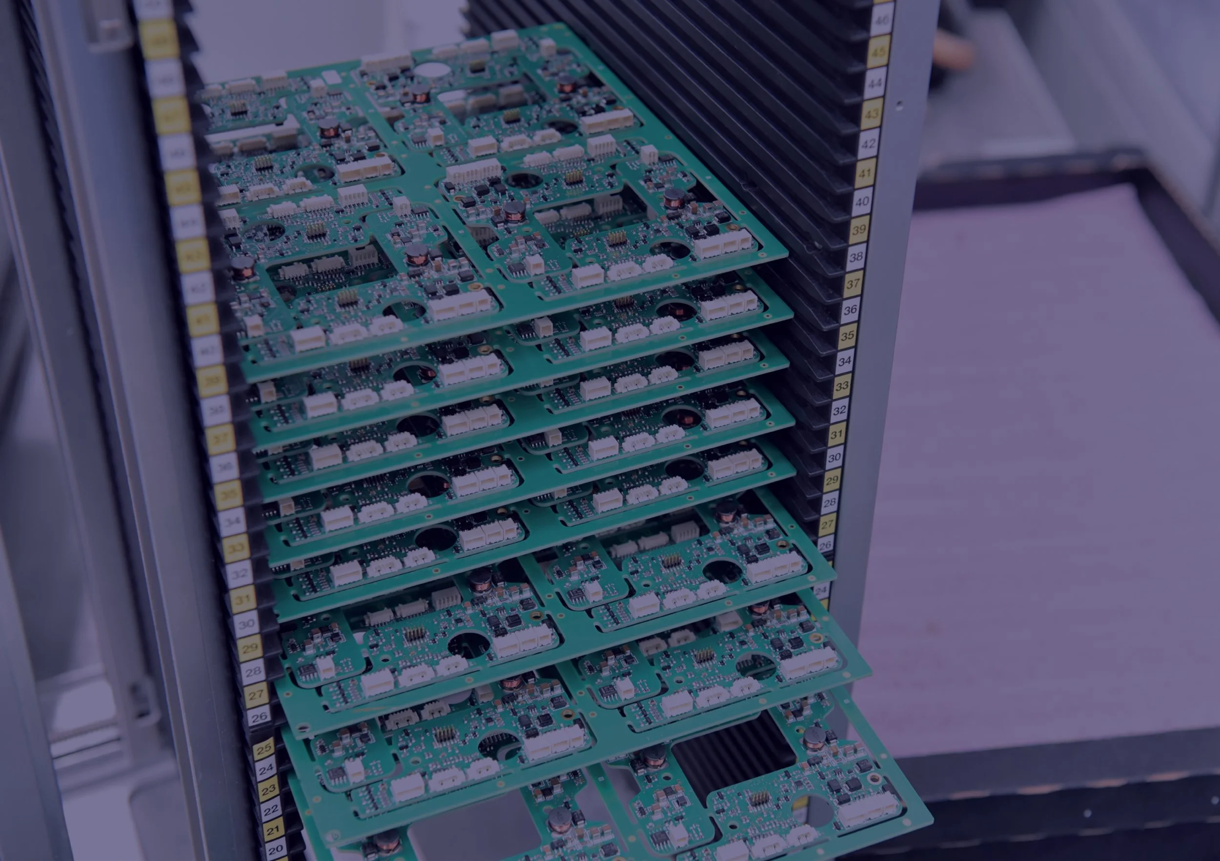 Assembled PCBs stored in an ESD-safe rack for quality-controlled electronics manufacturing and inventory management.