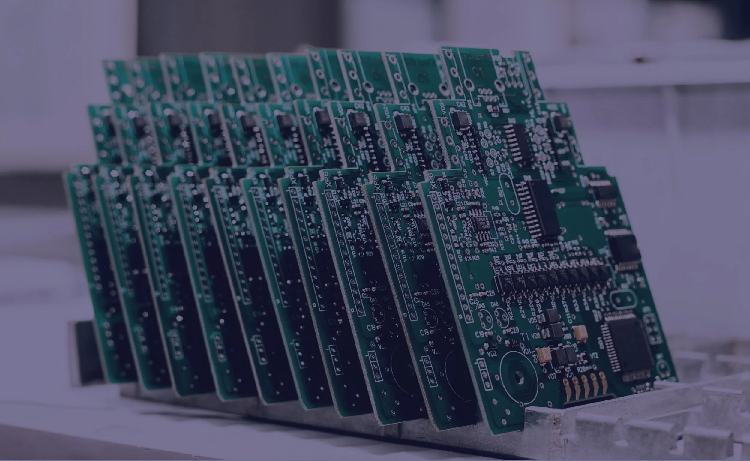A row of freshly assembled printed circuit boards ready for inspection and testing during the PCB assembly process.
