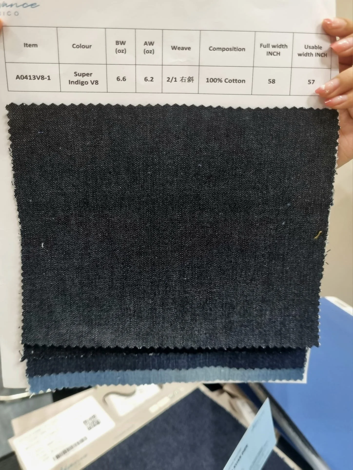 High-quality denim fabric sample showing custom indigo shades and specialized weave compositions from a vertical mill.