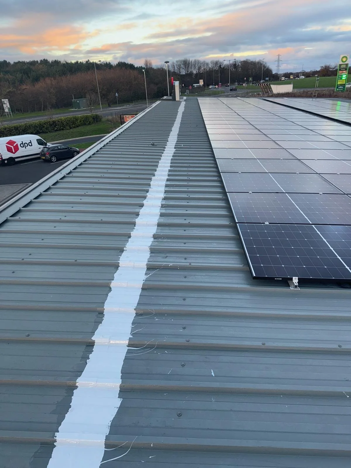 Cut edge corrosion repairs completed to metal roof sheets at an NHS property in Manchester.