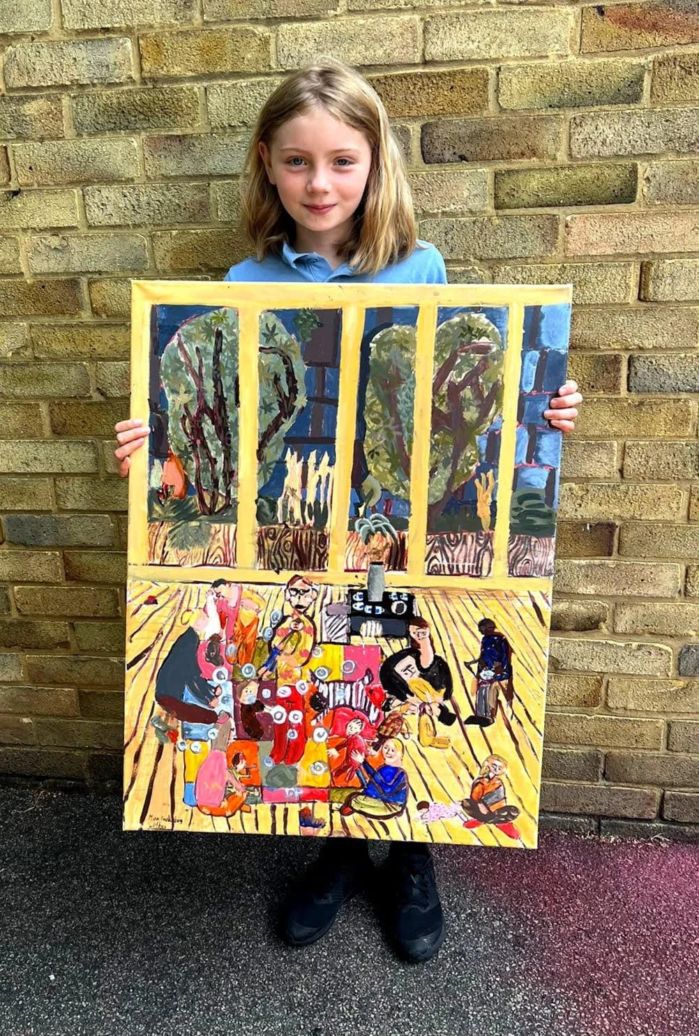 Mina holding her painting inspired by Songs & Smiles