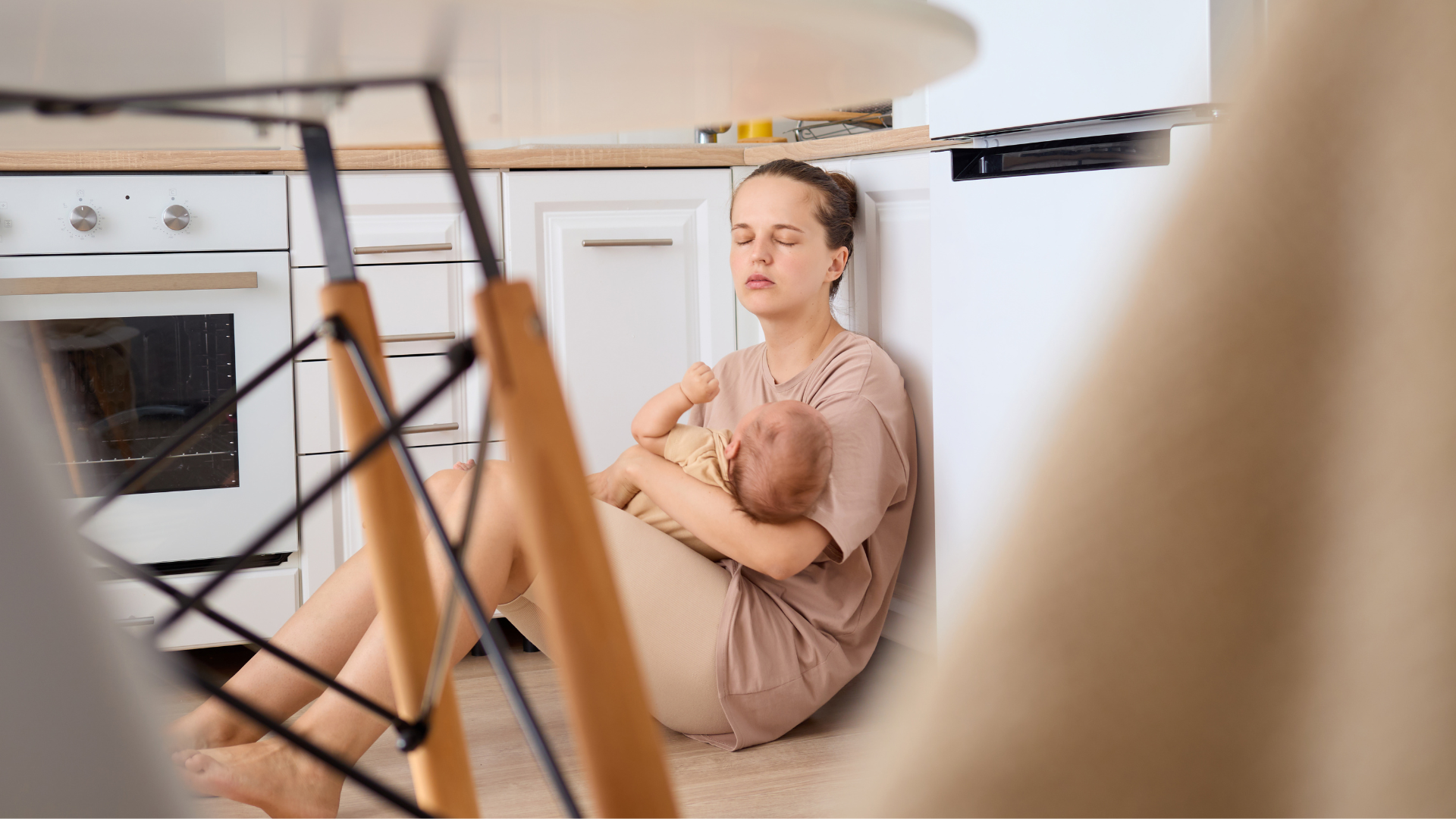A new parent holding a baby at home during a difficult moment in early parenthood