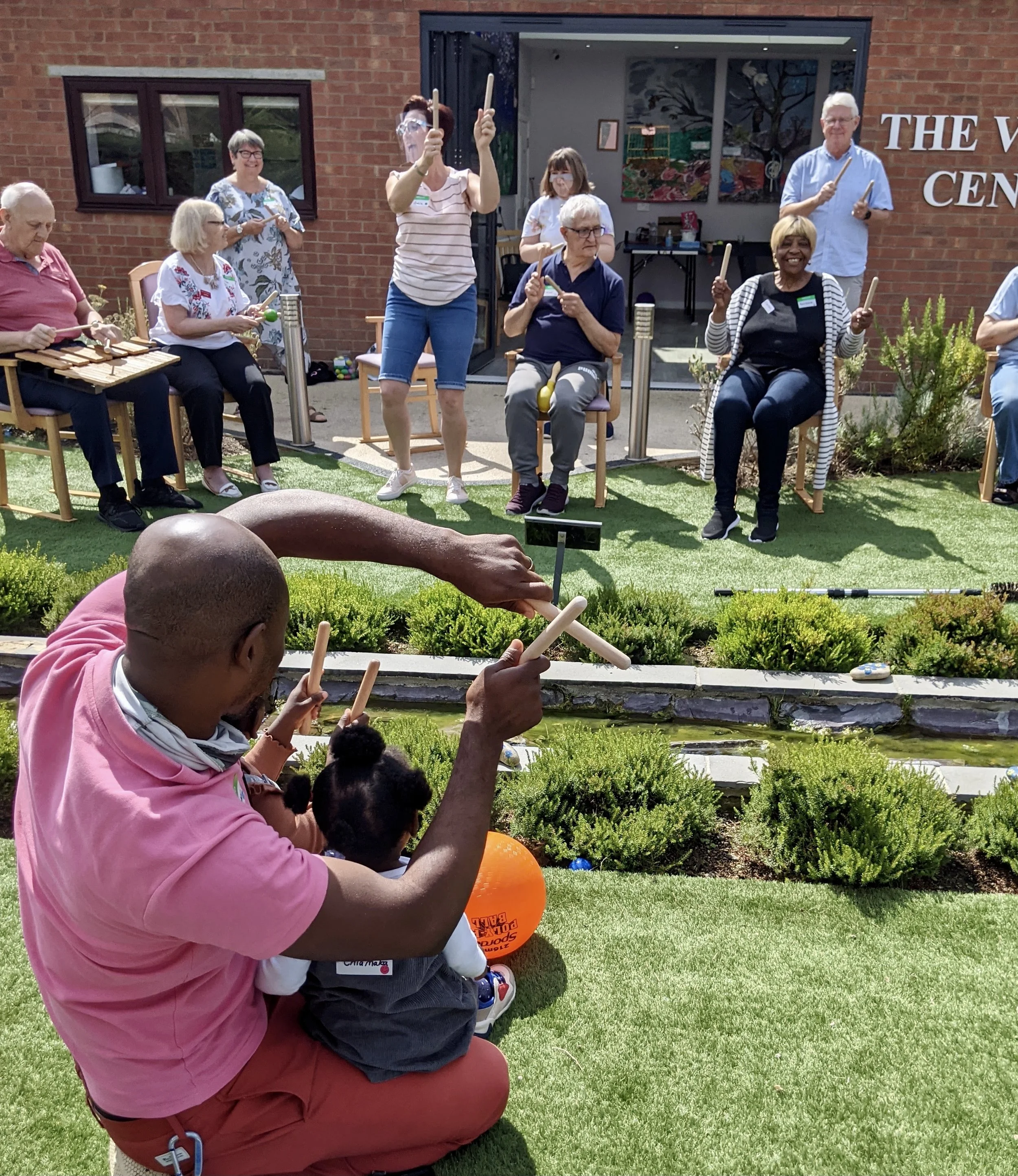 An outdoor intergenerational session showing music, movement and shared learning in action