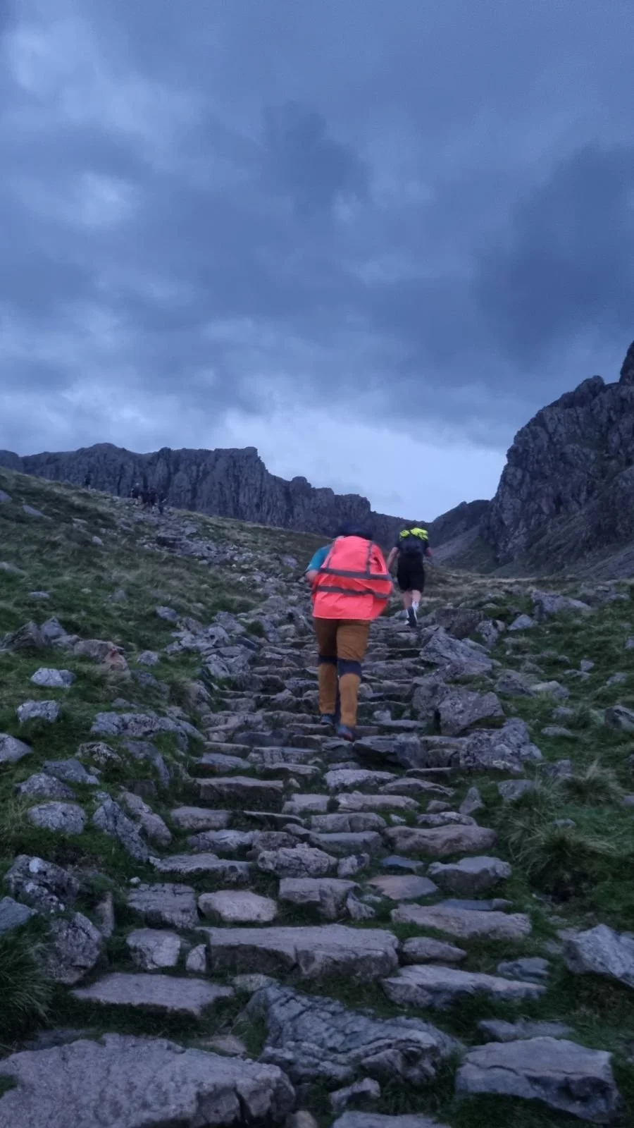 Hikers climbing a rocky mountain path during the National Three Peaks Challenge