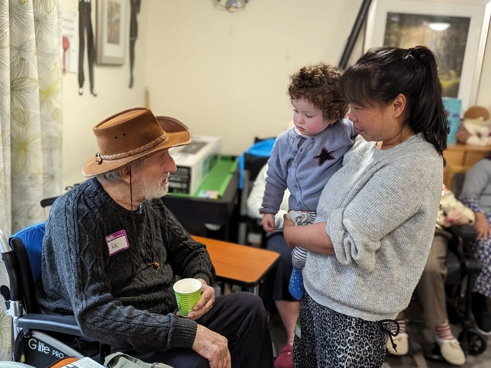 A Songs & Smiles moment of connection between a care home resident, parent and child