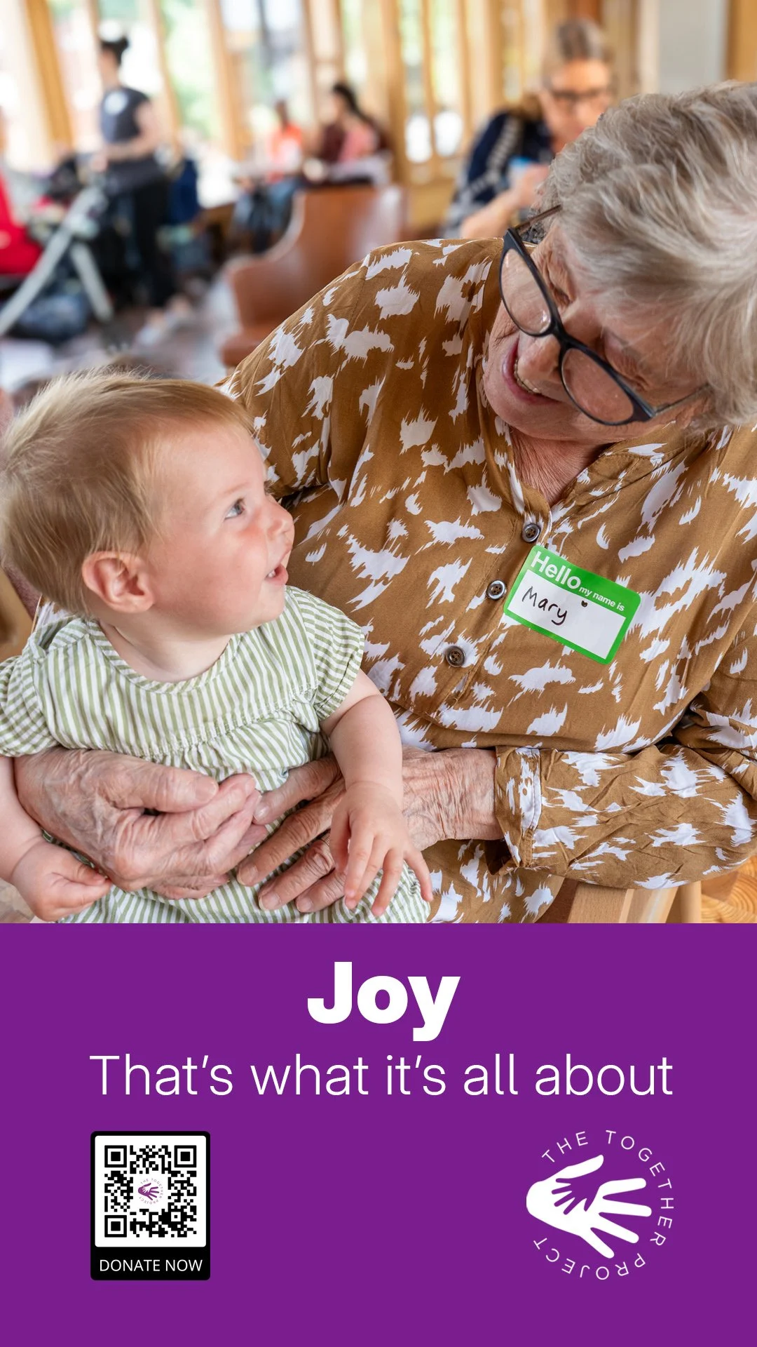 Campaign poster showing a joyful intergenerational moment with the word “Joy”