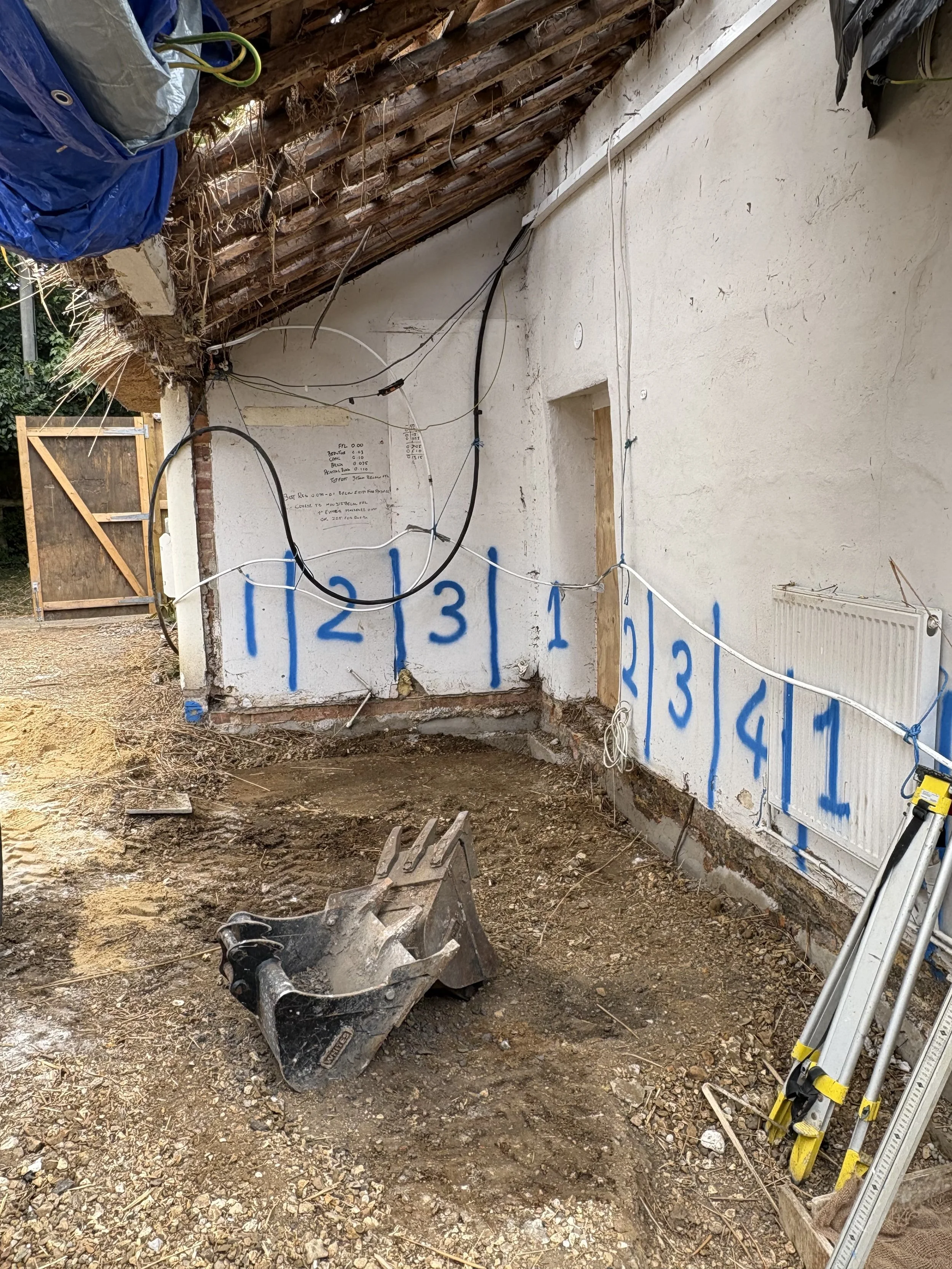 Cob wall construction project. New Forest. Underpinning to cob walls. Contemporary extension to historic cob cottage. Pell-Stevens Architects.