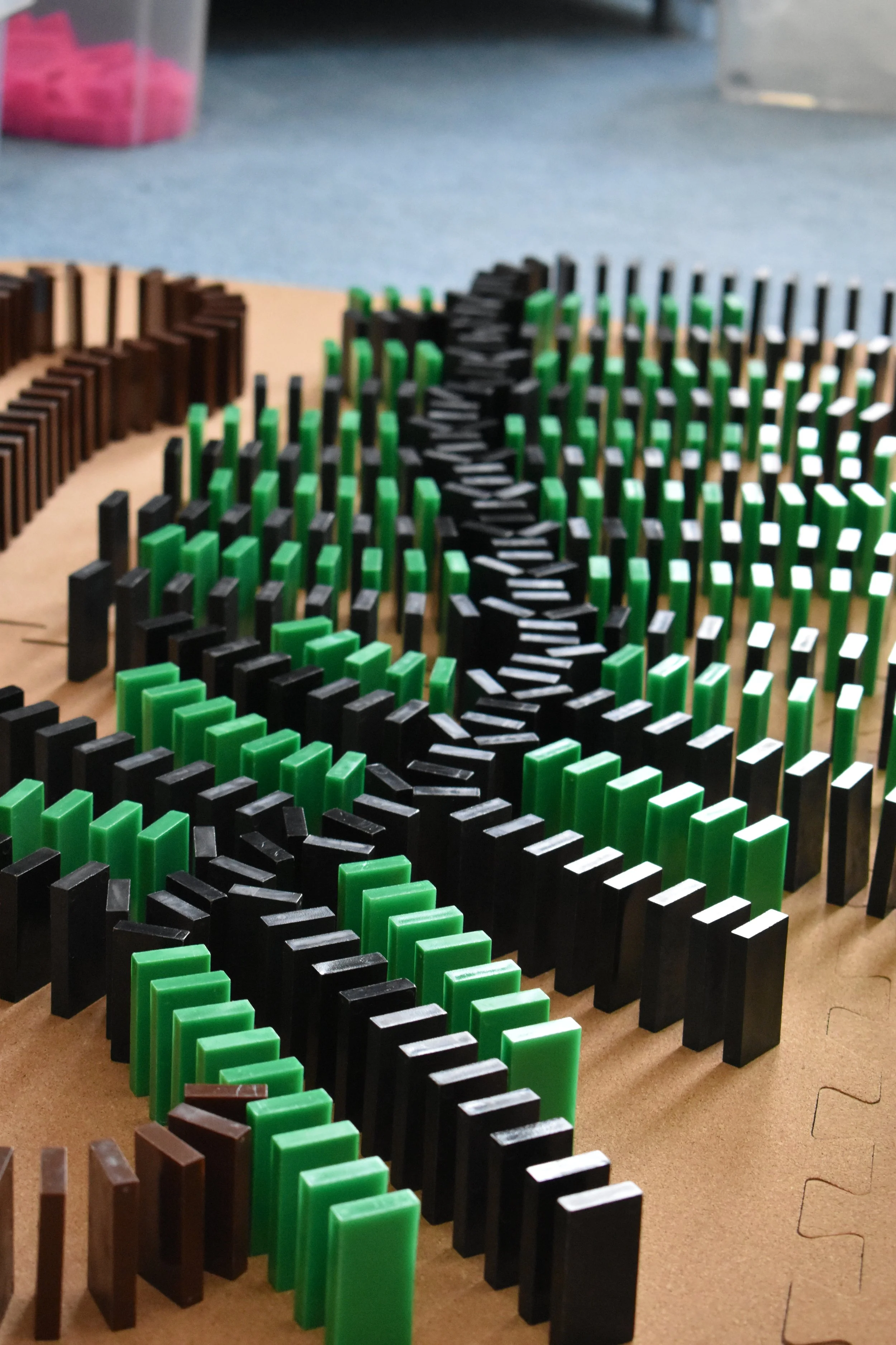 Colourful dominoes arranged in lines on a flat surface.