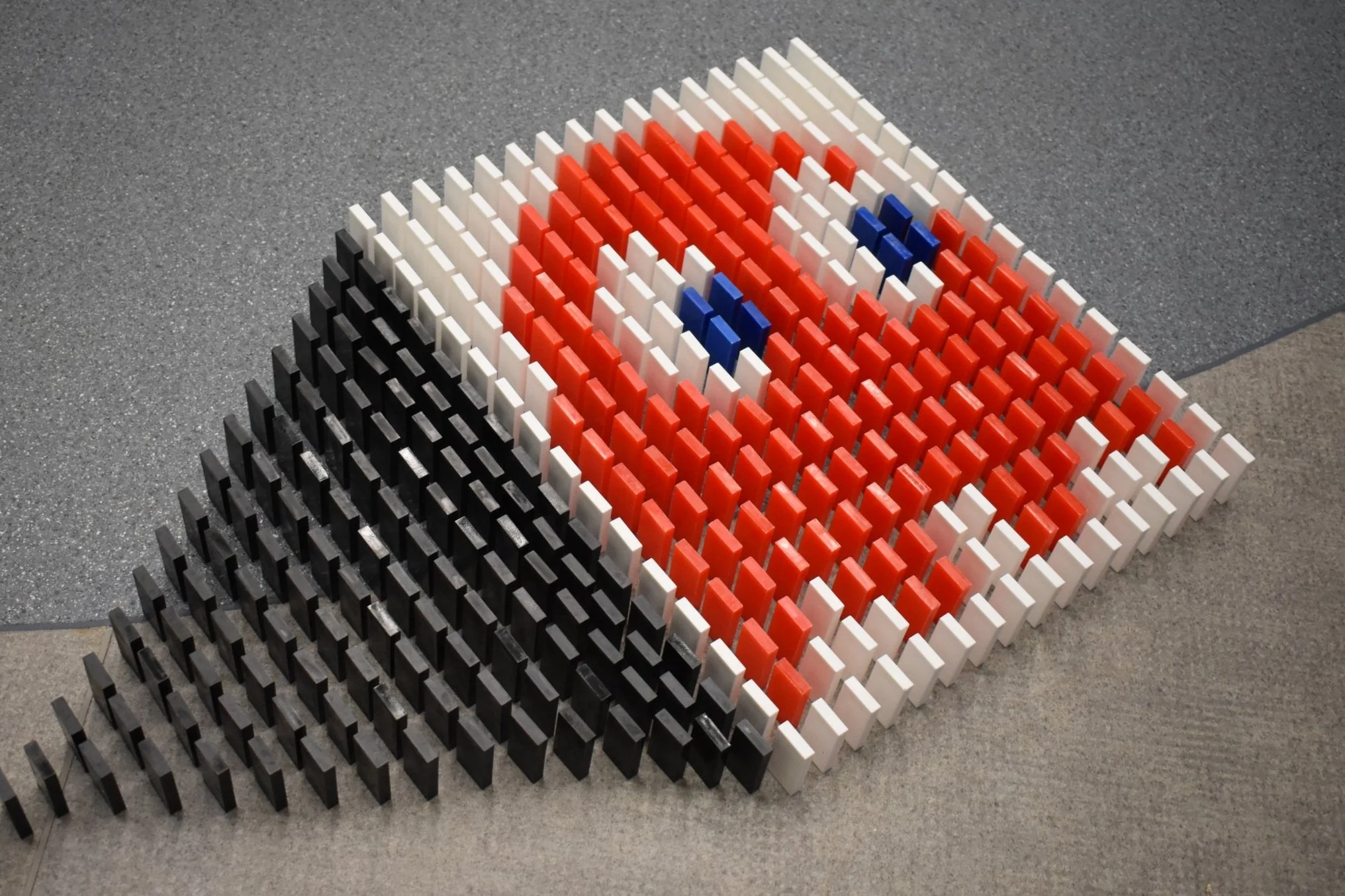 blinky from the pacman game built with red, while and blue dominoes