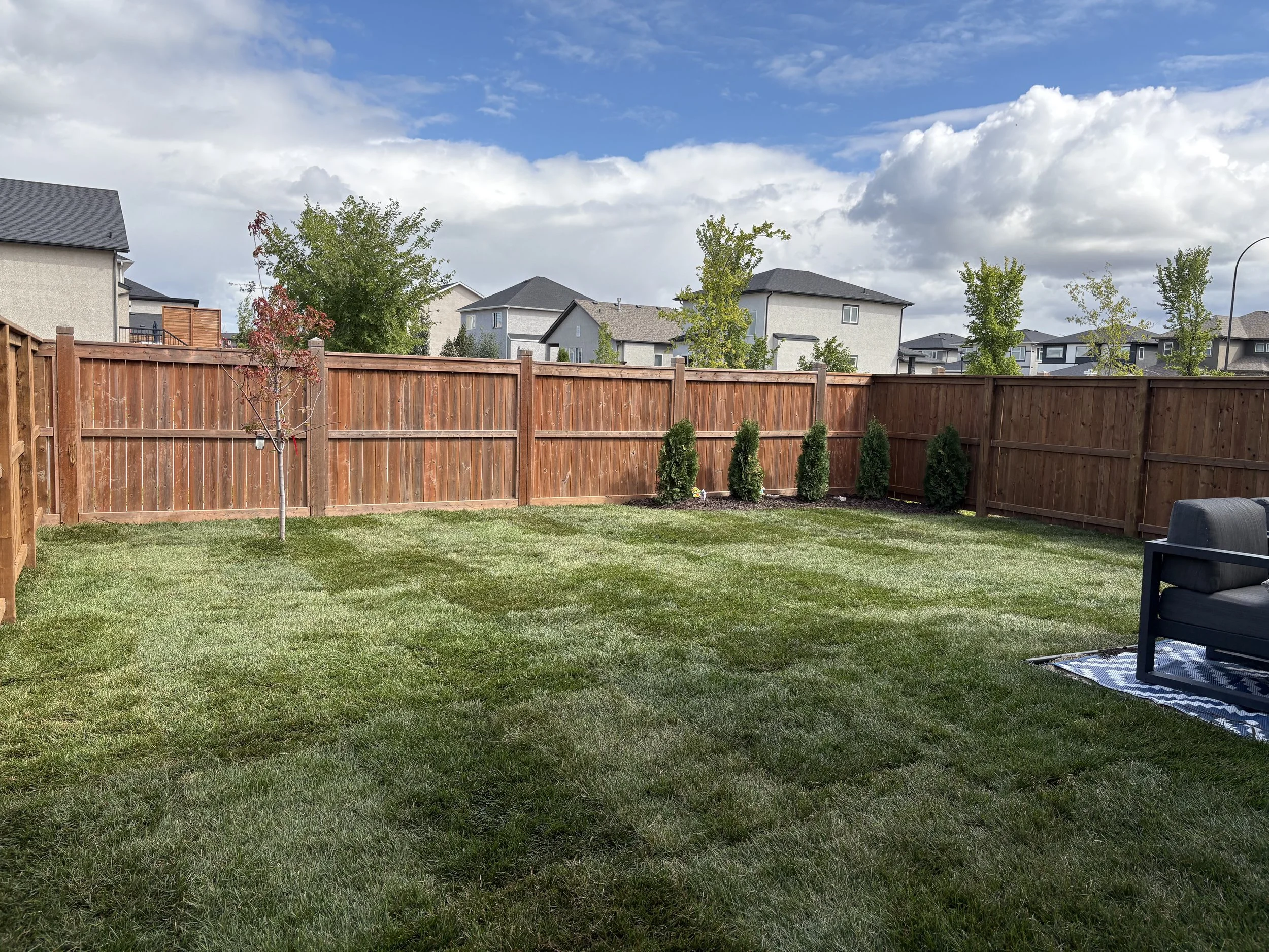 Professional sod installation in Winnipeg — we replaced the yard with fresh, high-quality sod for a vibrant, healthy lawn. This project also featured a custom wood landscape border, a low-maintenance pea gravel section, and a stylish black granite ro