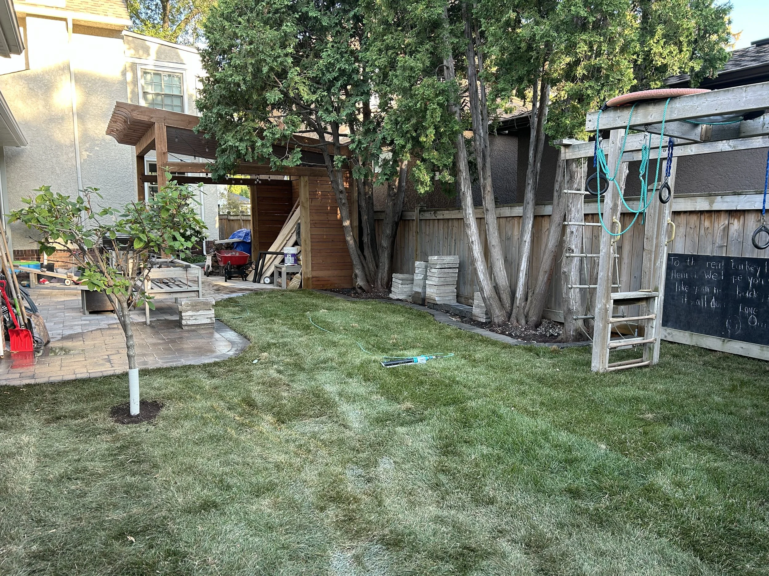 Winnipeg landscaping project featuring fresh sod installation creating a healthy green backyard lawn