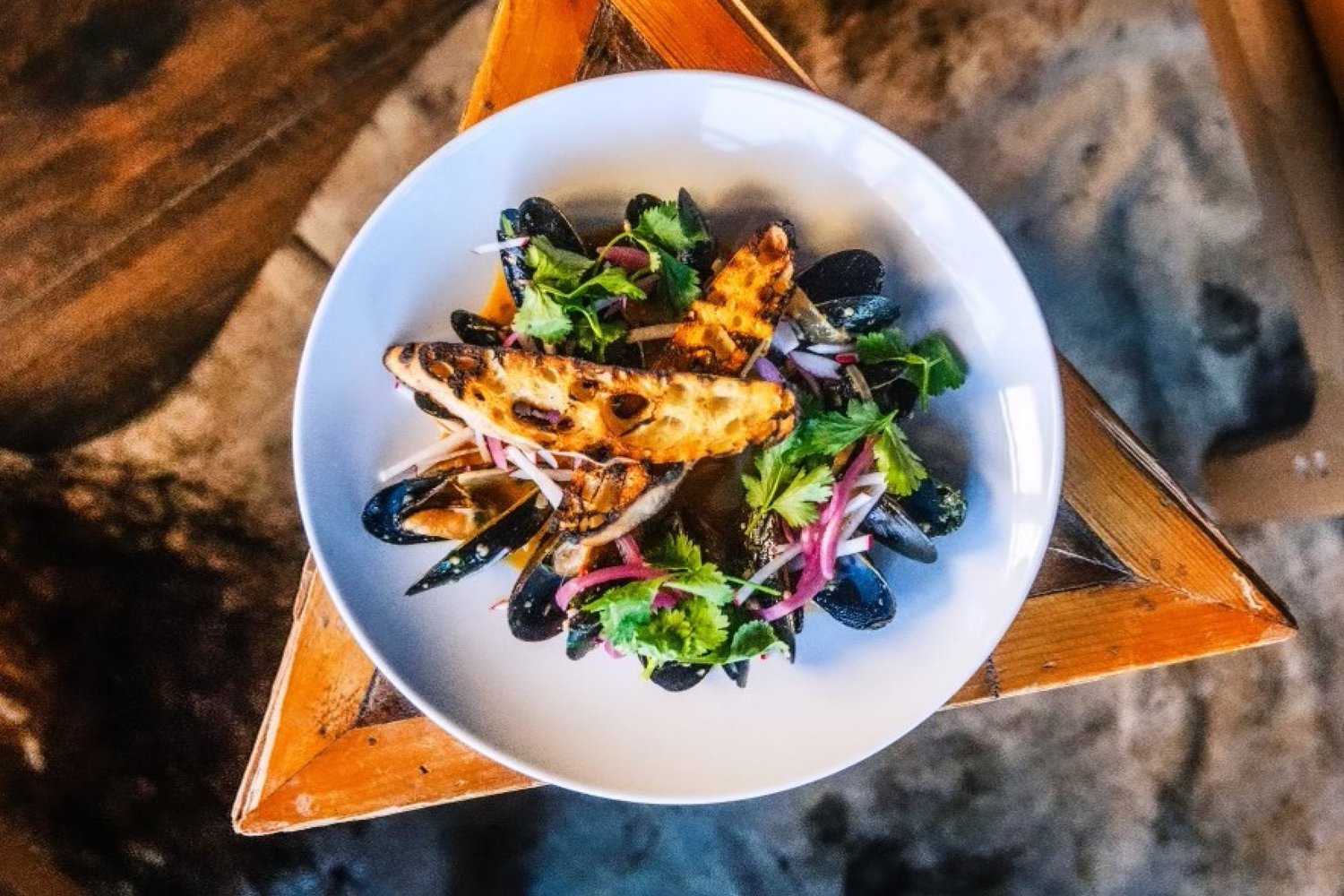 Mussels with grilled bread, cilantro and pickled onion
