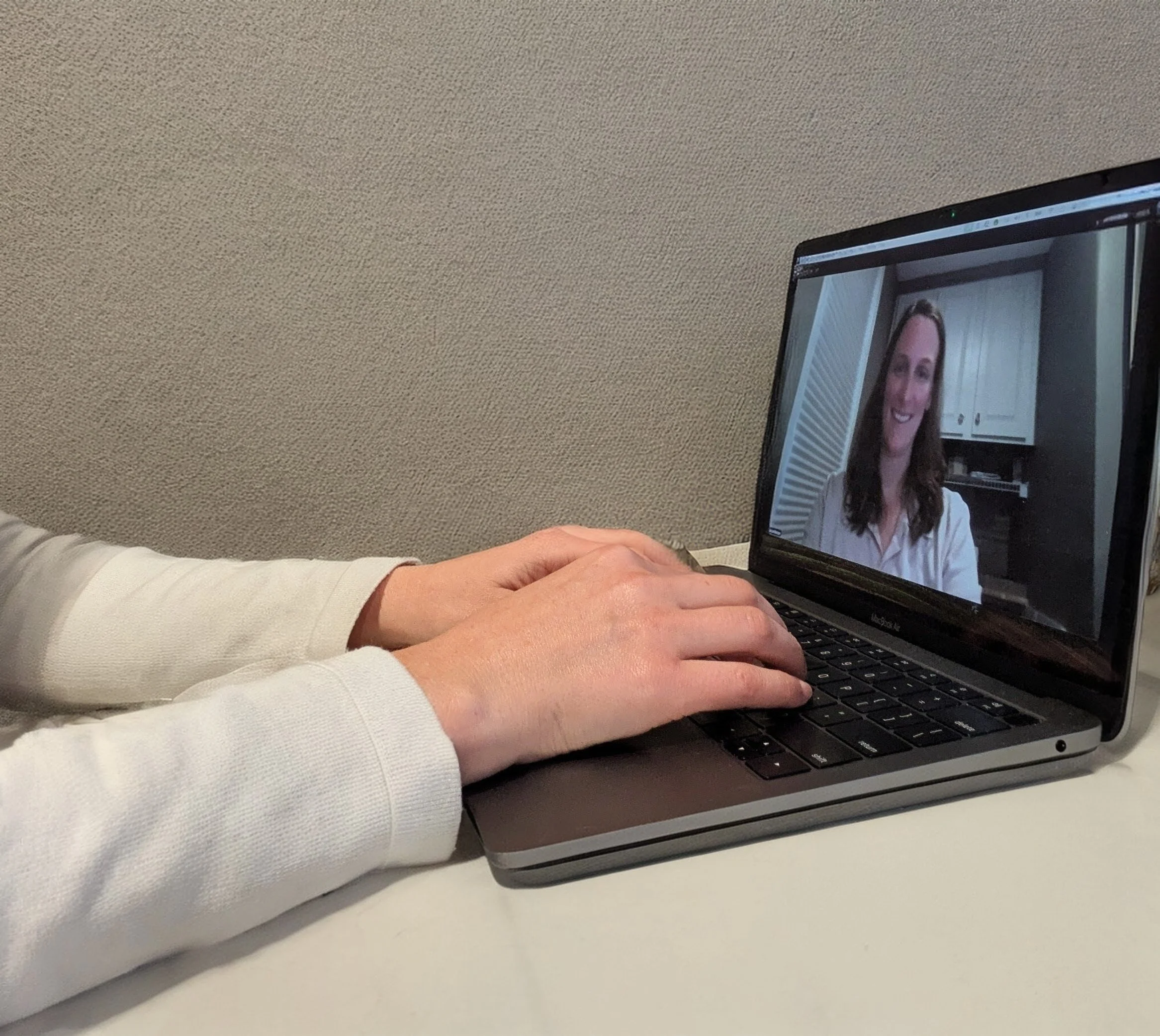 Photo of Katie Badger conducting a video telehealth appointment.