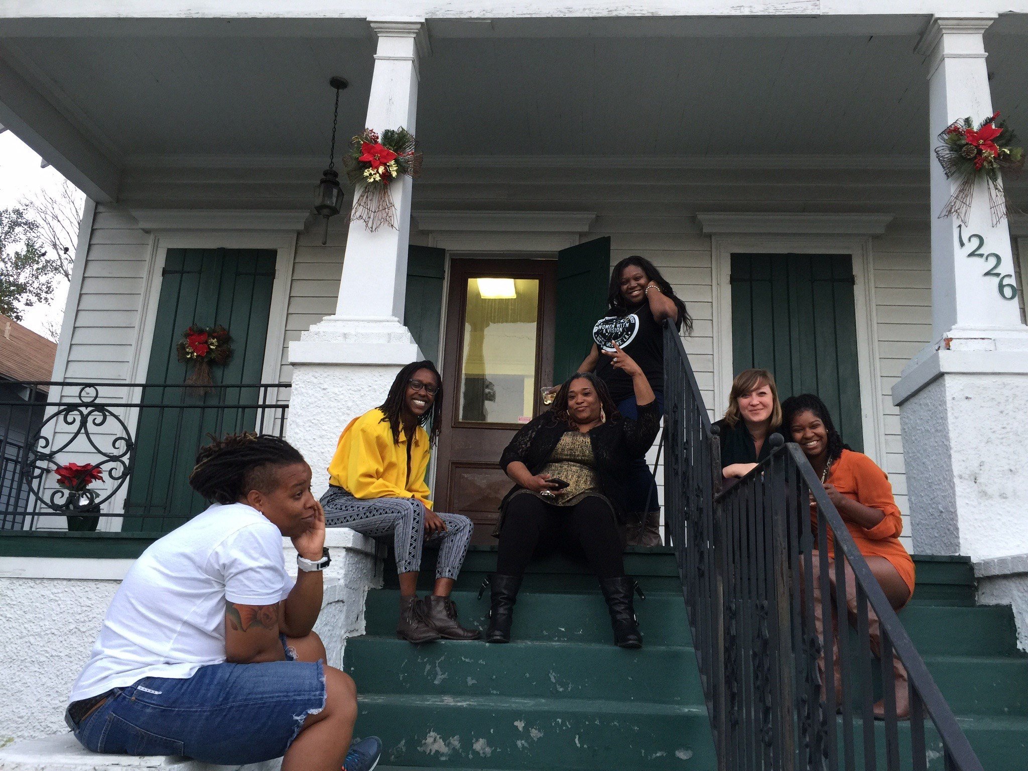  Shaquita Borden, Mwende Katwiwa, Deon Haywood, Nakita Shavers, Laura McTighe, and Nia Weeks sitting on WWAV’s front porch at 1226 N. Broad Street in New Orleans, Louisiana, December 16, 2015. 