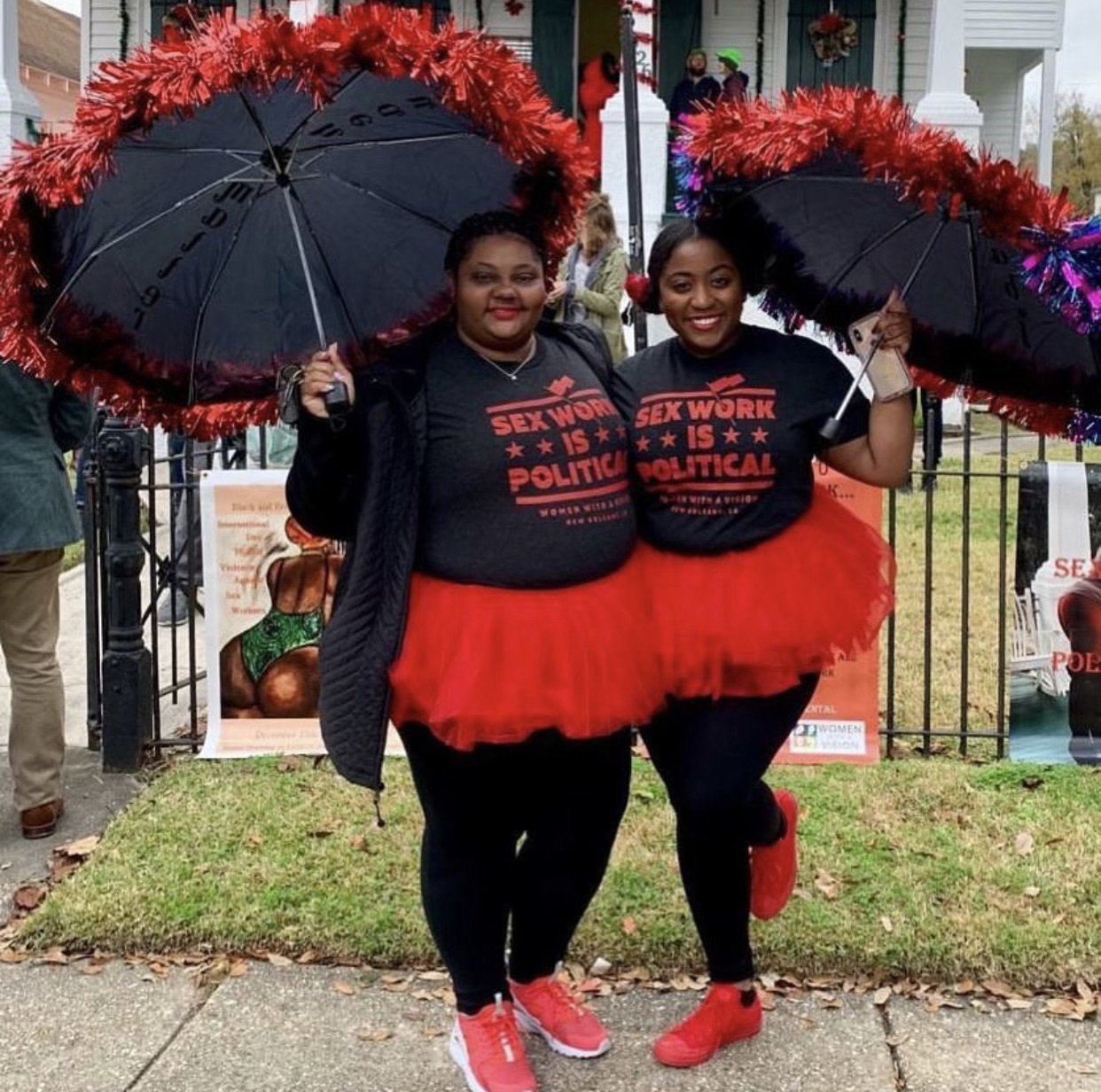  Raven Frederick and Elsye Defree in their “Sex Work is Political” T-shirts, holding red umbrellas before the 2nd Annual Black and Brown Sex Worker Second Line begins on the International Day to End Violence Against Sex Workers, December 15, 2018.  P