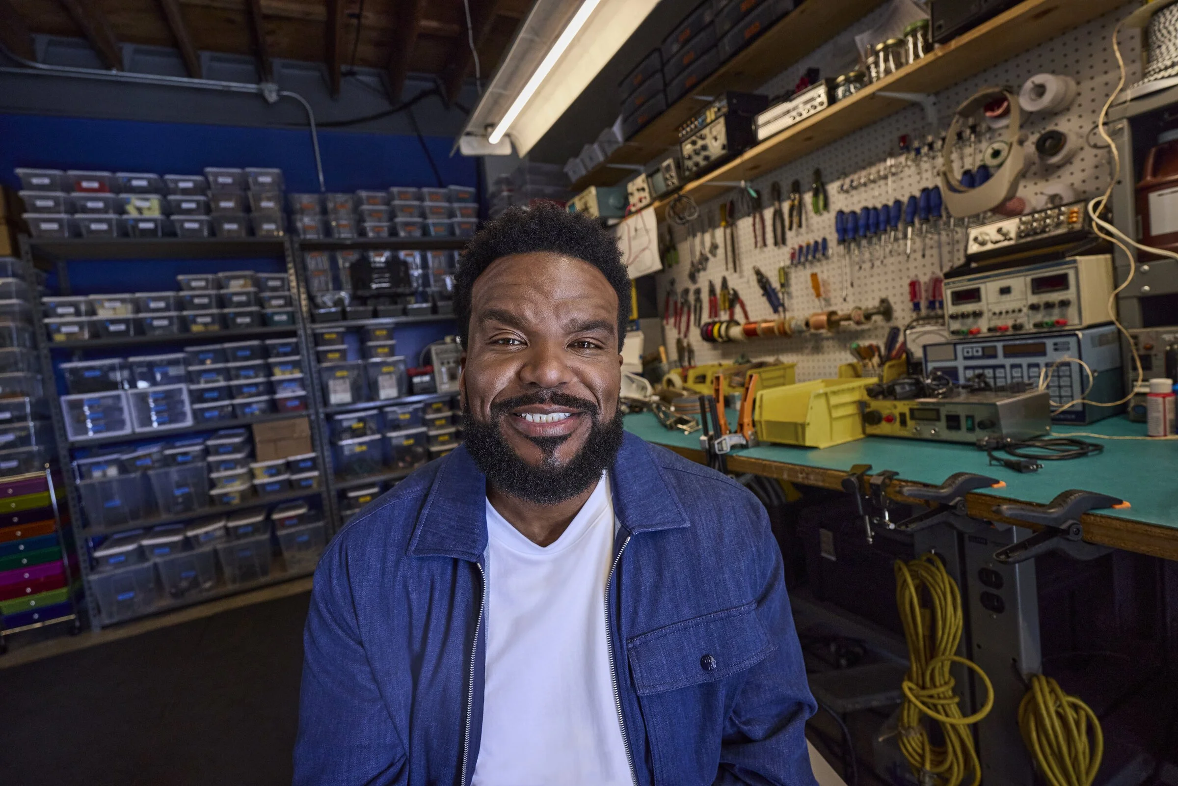 Craig Robinson smiling in the CrAIg workshop