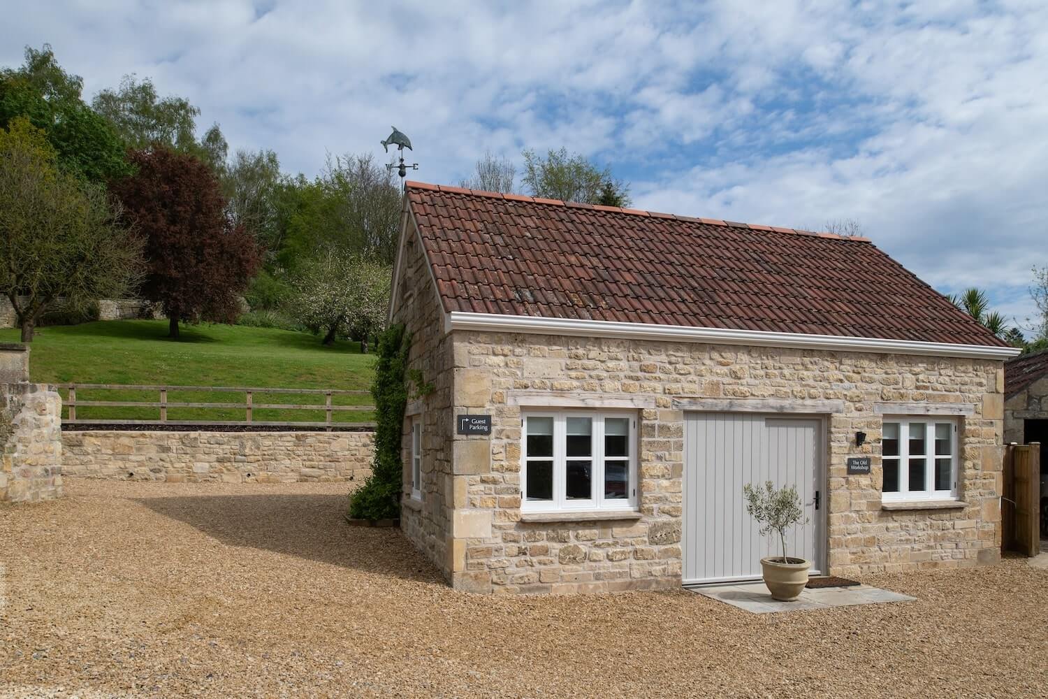 The-Old-Workshop-holiday-cottage-parking-yard-and-front.jpg