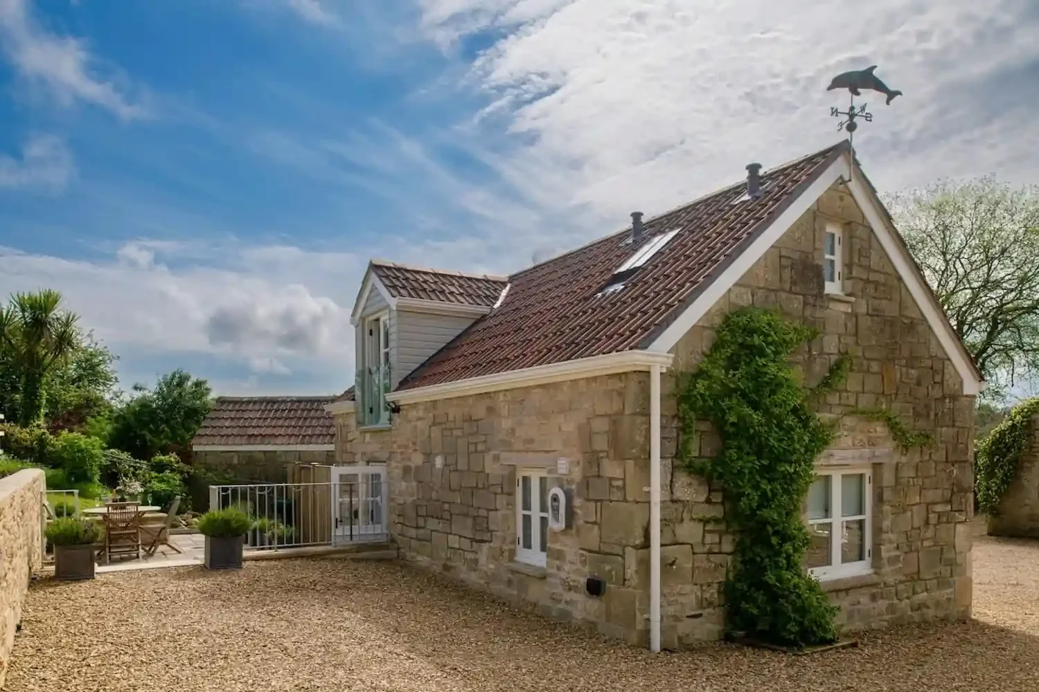 The Old Workshop Monkton Combe Holiday cottage rental rear patio and parking area with EV charger