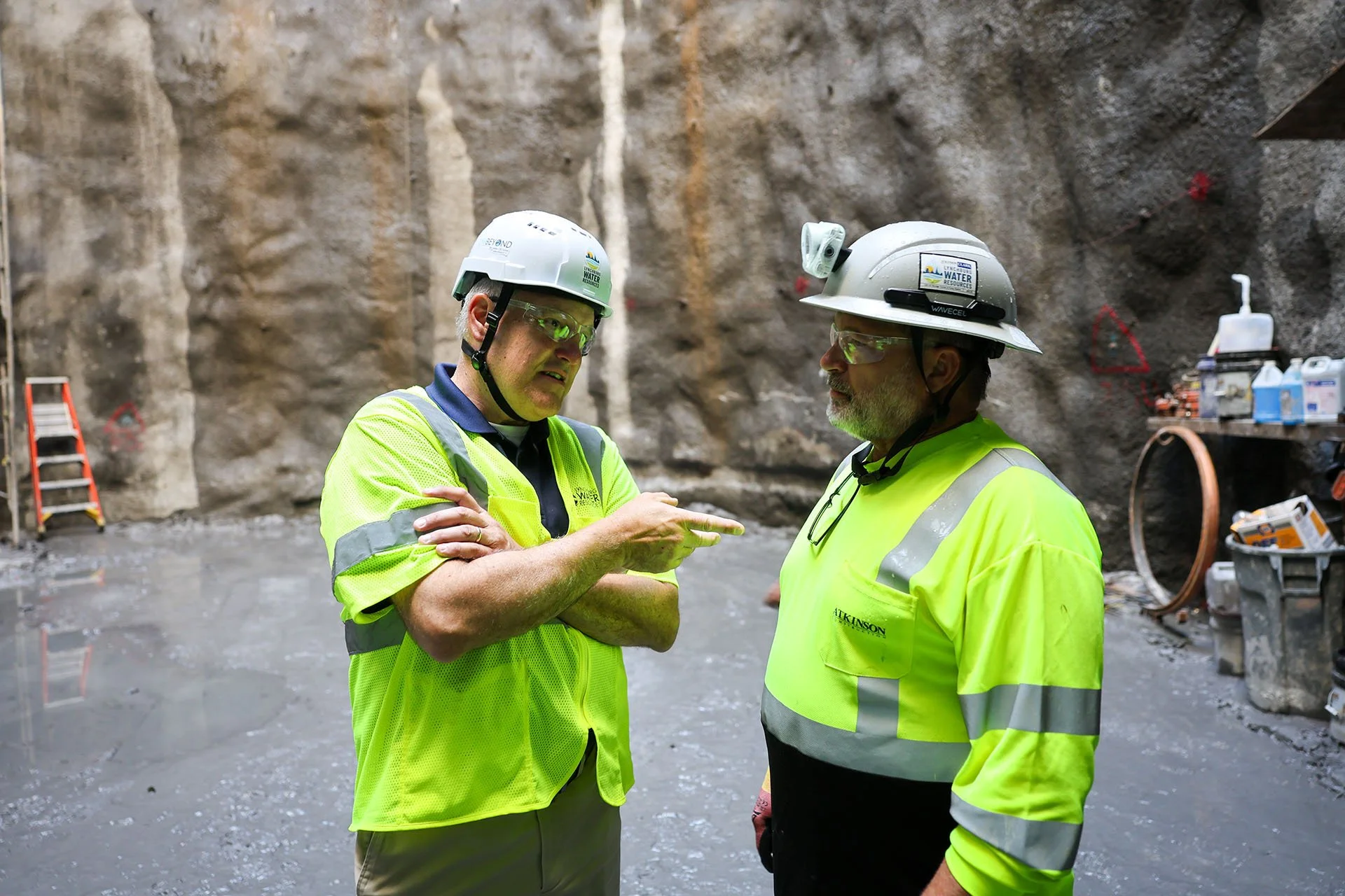Lynchburg Water Resources Director Tim Mitchell talks to a construction worker in the tunnel.