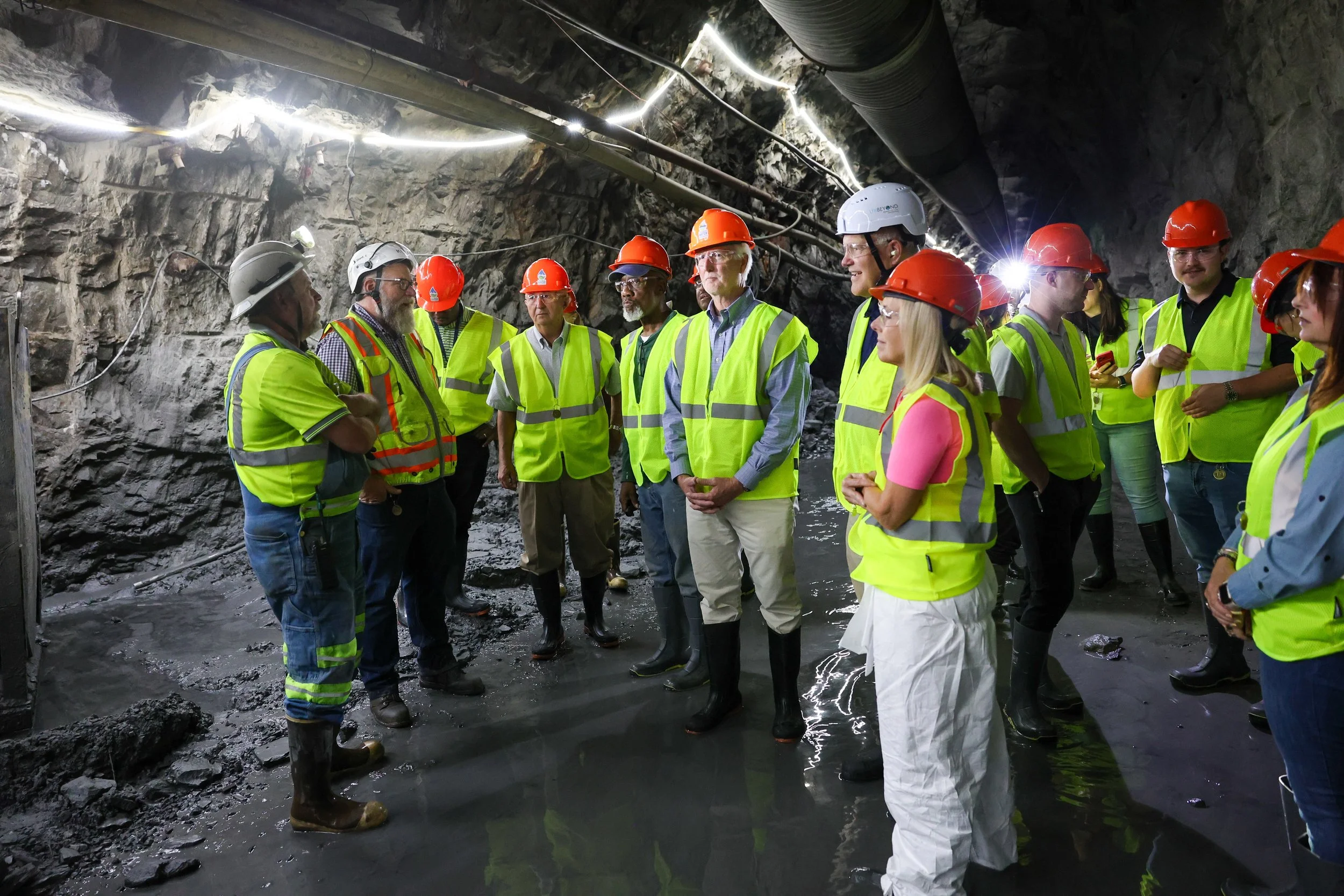 Tour guests listen to Stantec's Kevin Kilby inside the excavated tunnel path.