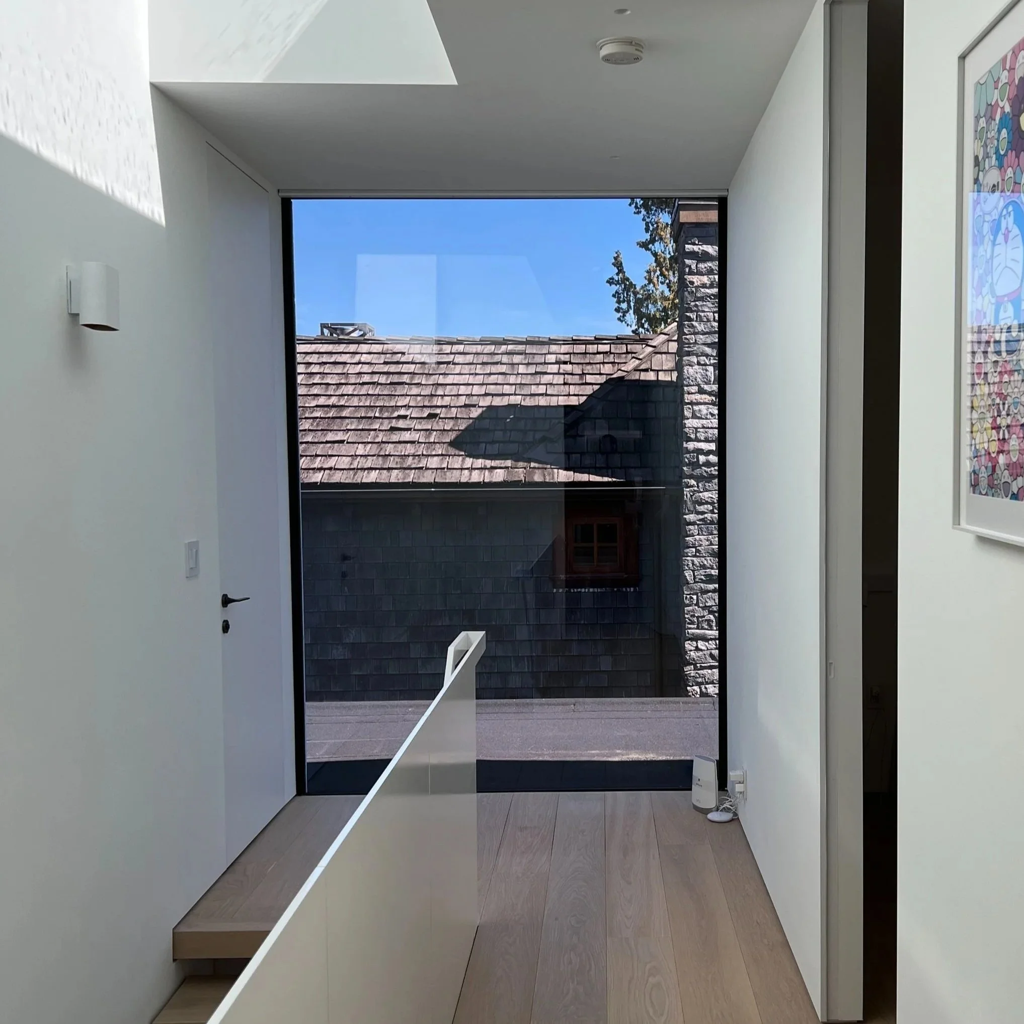 Hard Edge Drywall Finishing Work - Base of Wall Shadow Reglet Detailing. Trimless door frame installation and base shadow reglet detailing to base of door frame - new construction, finishing subcontract.