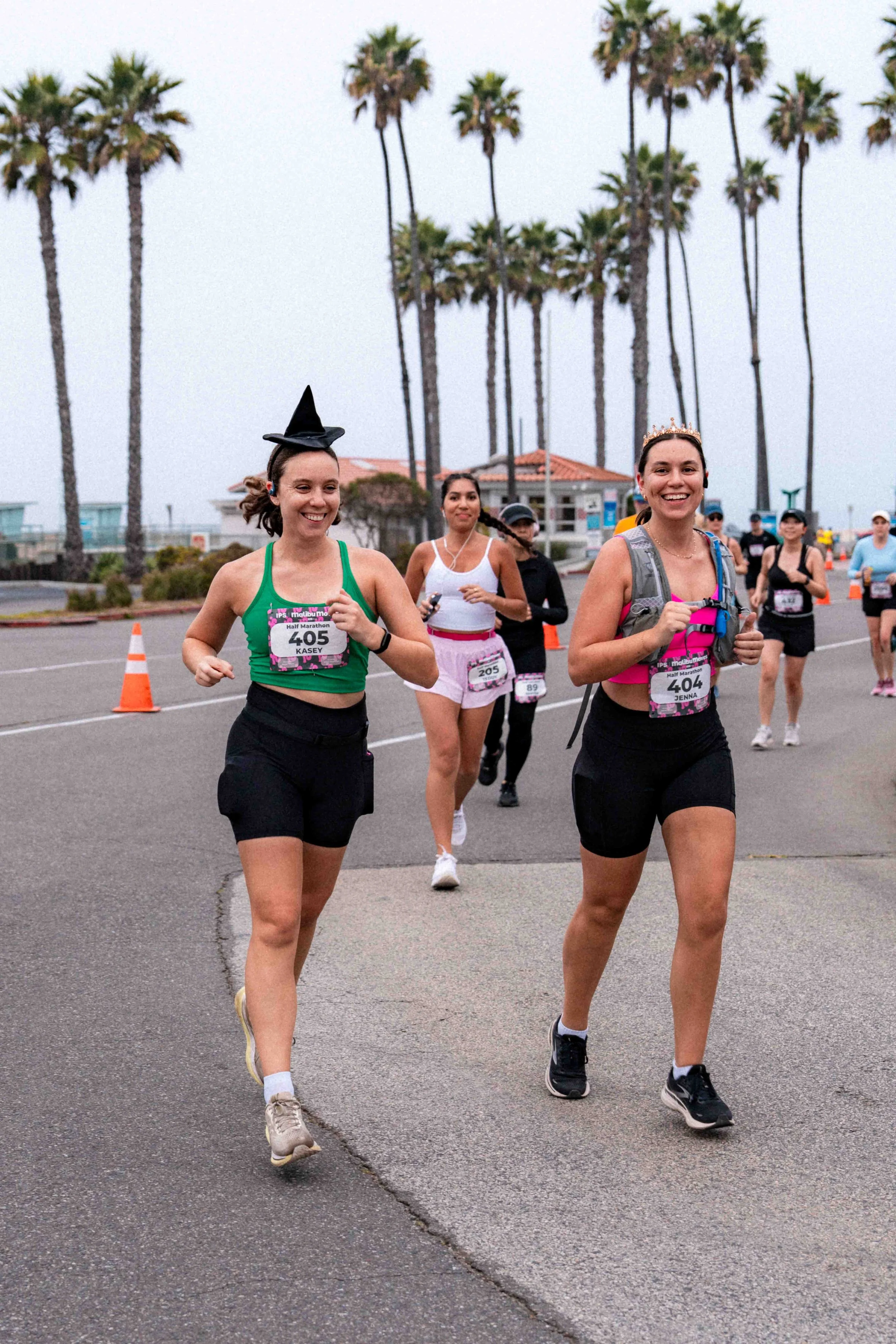 Three participants running along the scenic Malibu coastline during the Malibu Moves race weekend.