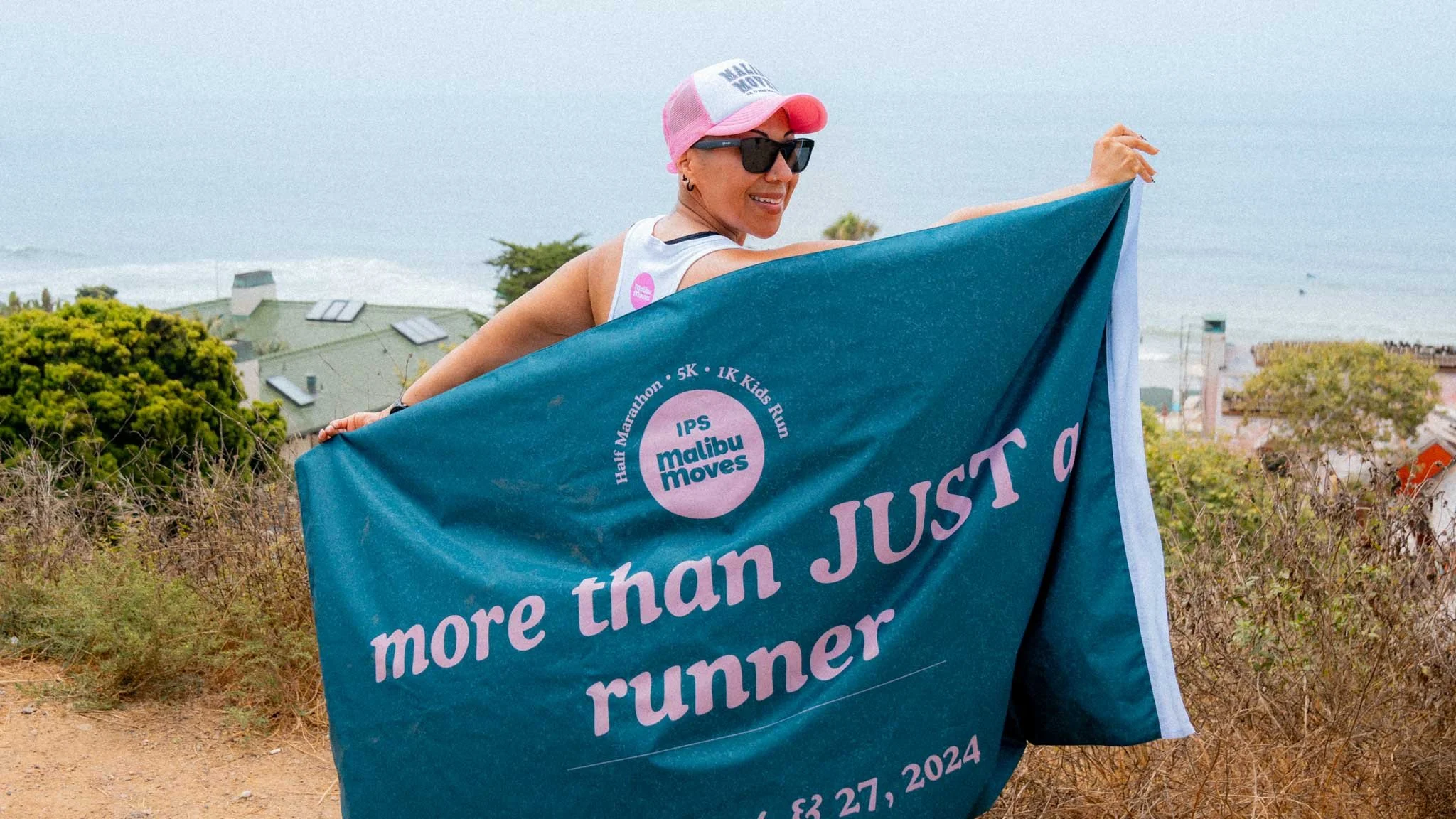 Malibu Moves ambassador Jen holding the event flag 'more than JUST a runner'