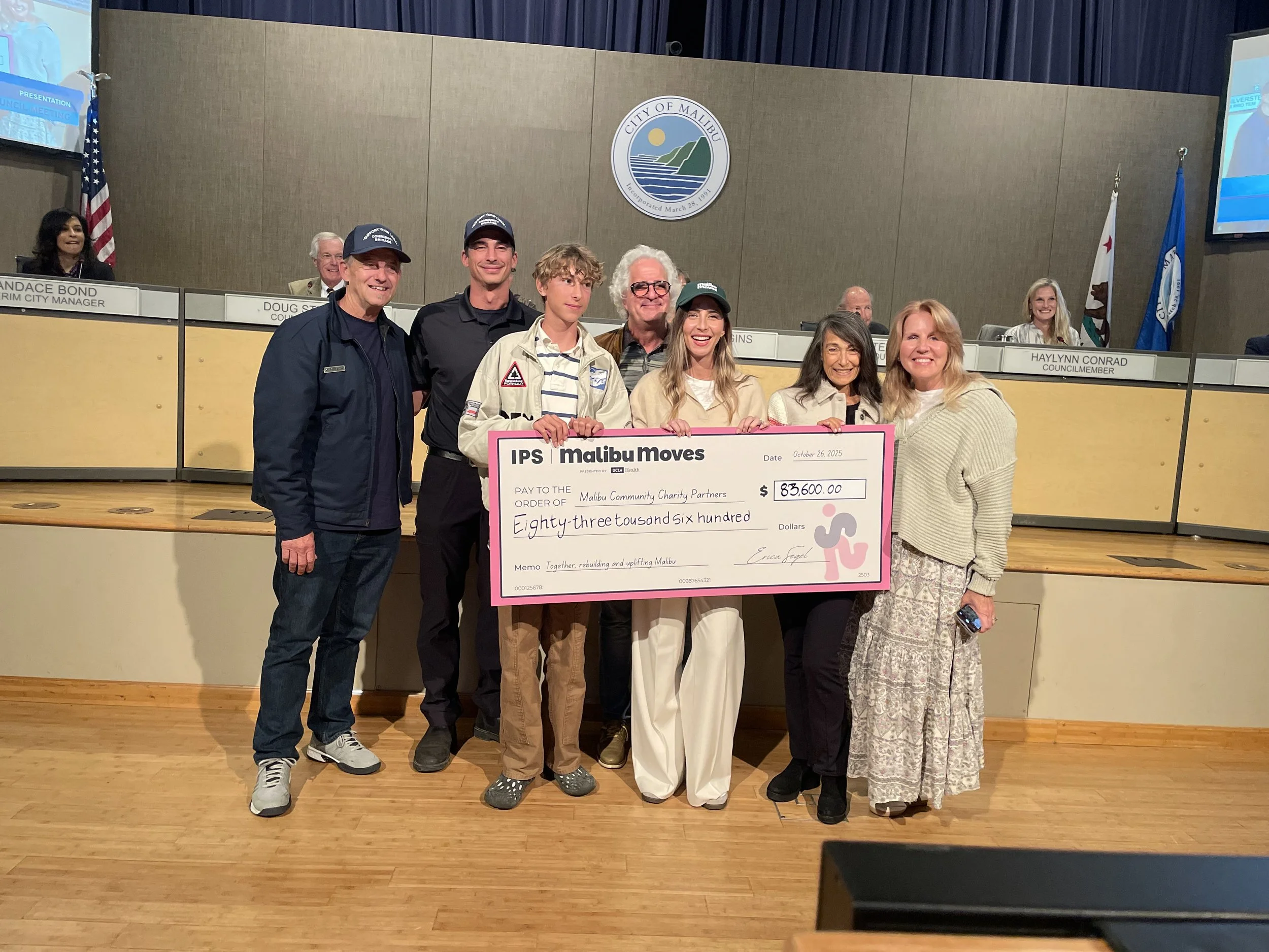 Founder Erica Segel and the Malibu Moves team presenting a donation check for eighty-three thousand six hundred dollars to local charity partners at Malibu City Hall.