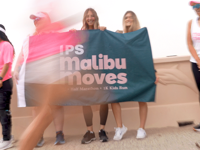 Malibu Moves Ambassadors running along Zuma Beach during a meetup.