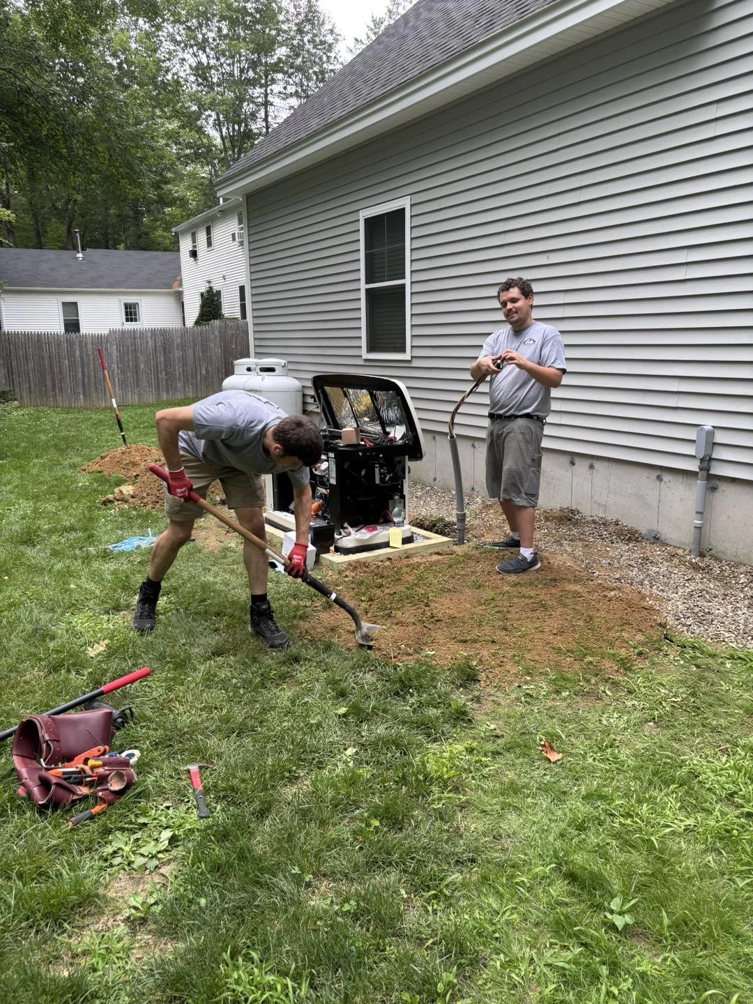 Generac whole home generator almost done with team members Peak Electric Windham Maine.jpg