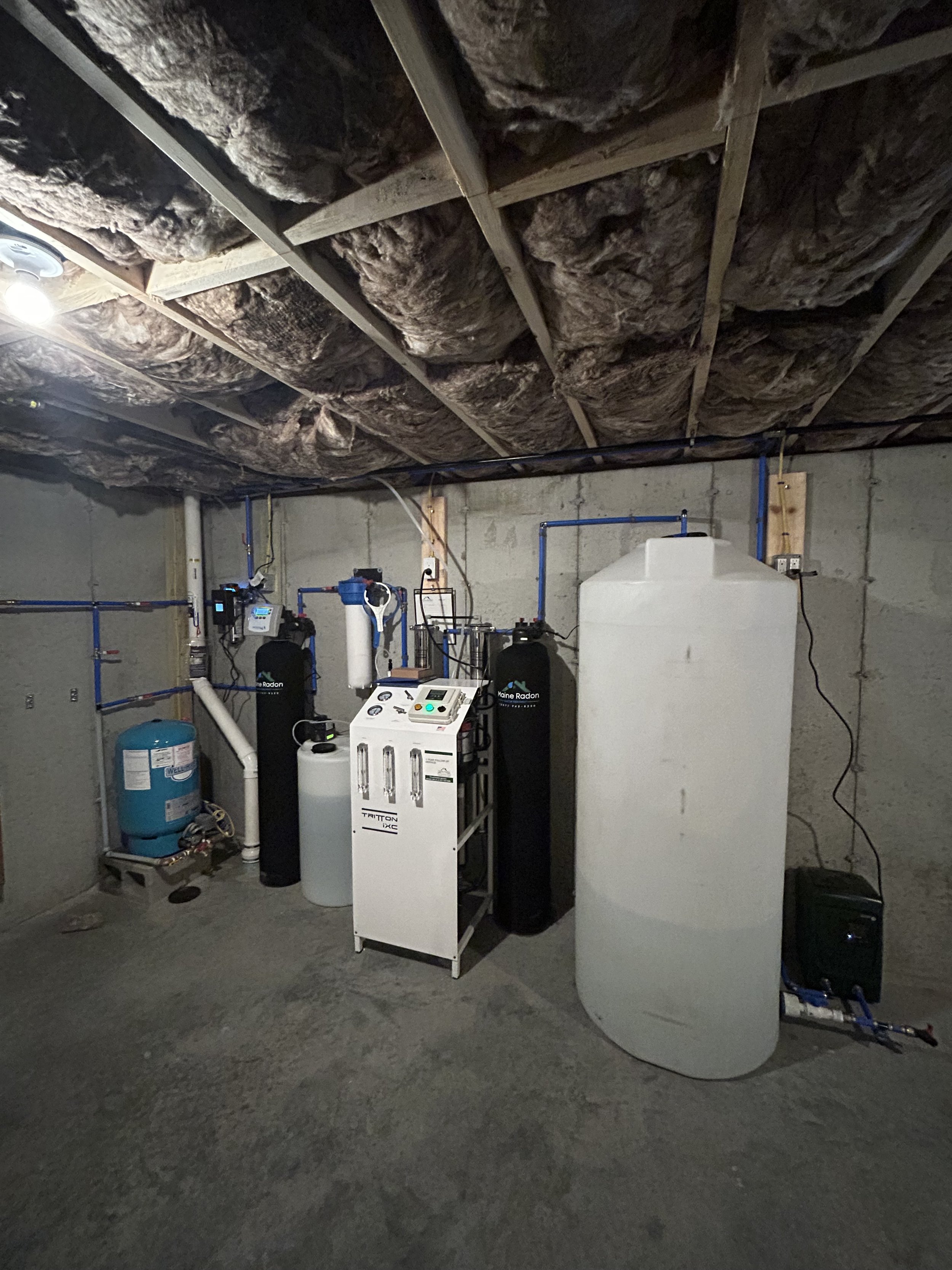 Basement with water treatment system, including tanks and pipes