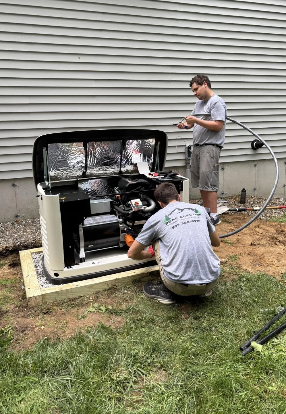 Generac generator mid-service by two of the Peak Electric team members