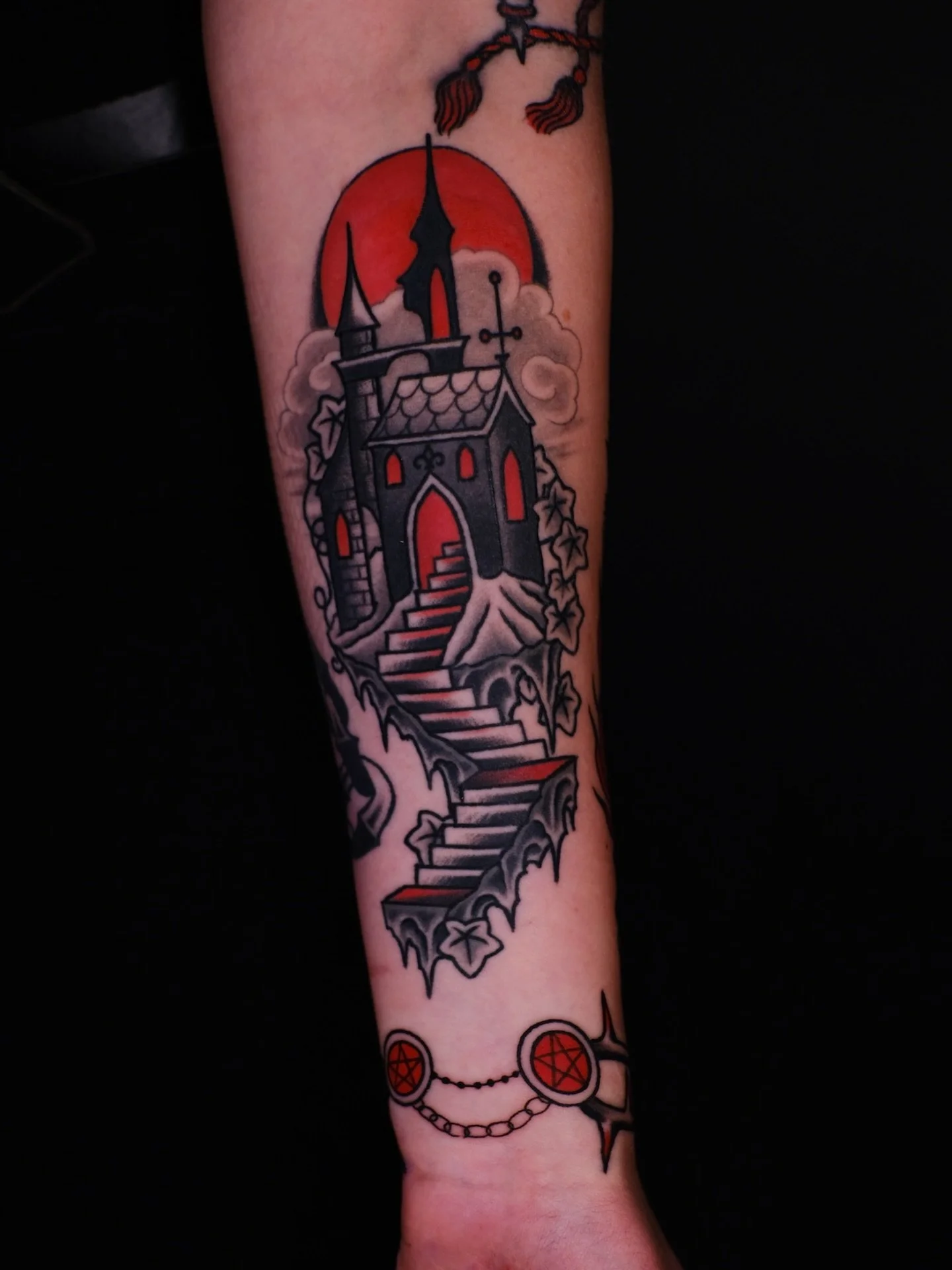 Gothic castle and fire dancing demon wrapping around the forearm by @handoftheforge 
Caroline is in the shop Sundays - Wednesdays and accepts appointments and walk-ins. Fill out the form in our bio to book or stop by the shop to grab a walk-in!