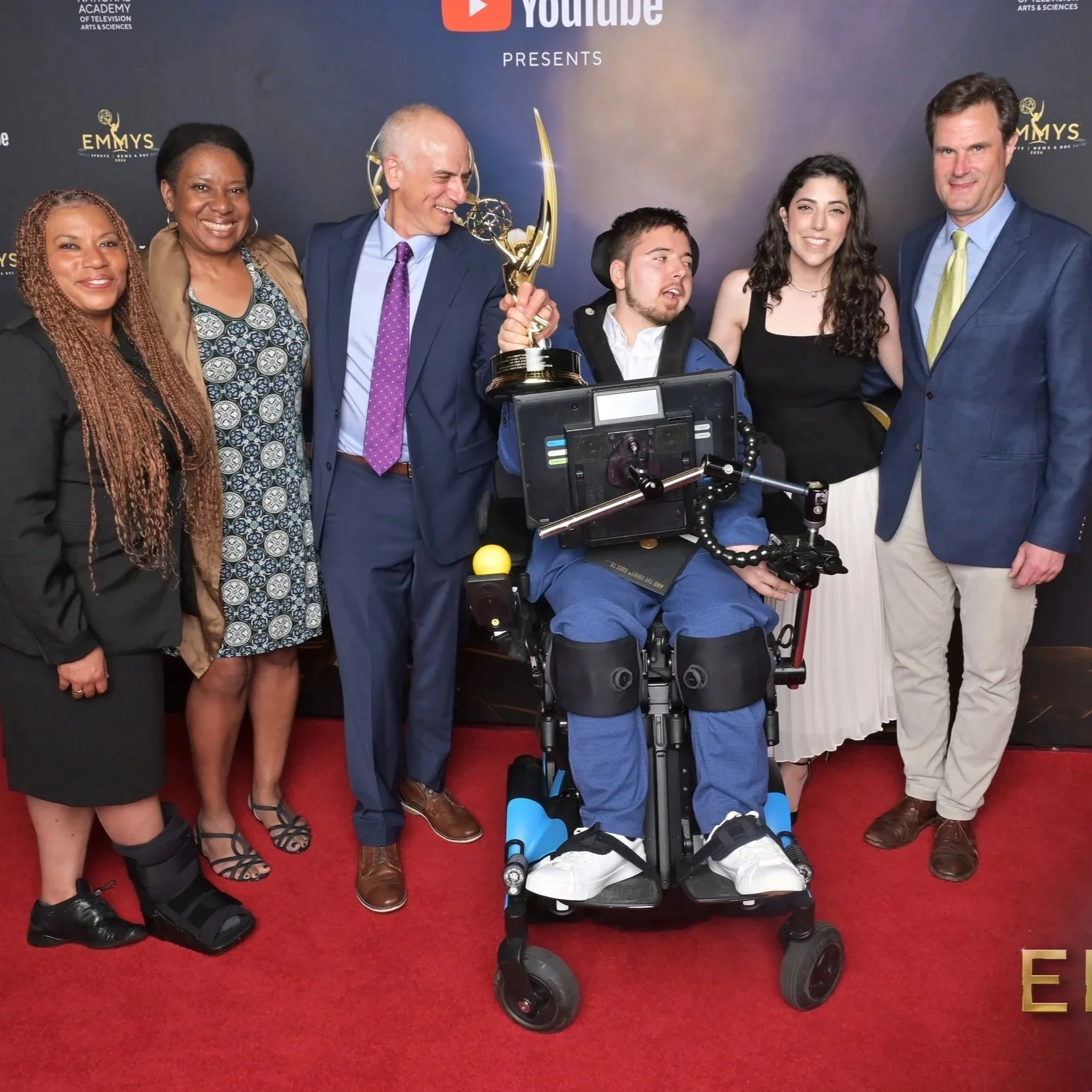 Photo of The Ride Ahead team with their Emmy on the red carpet