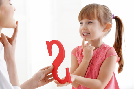 Woman holding a letter s showing a child how to make the sound