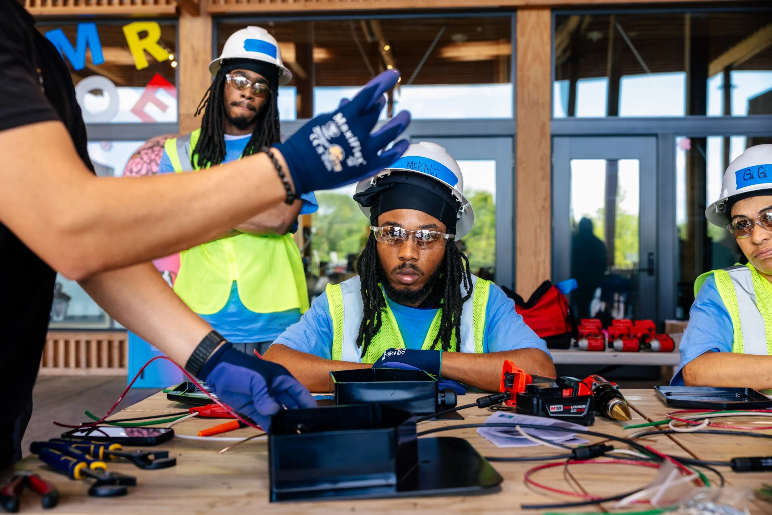 GRID Alternatives IBT 120 trainees practice electrical wiring skills during solar installation training at the Sycamore and Oak facility in Washington, D.C.